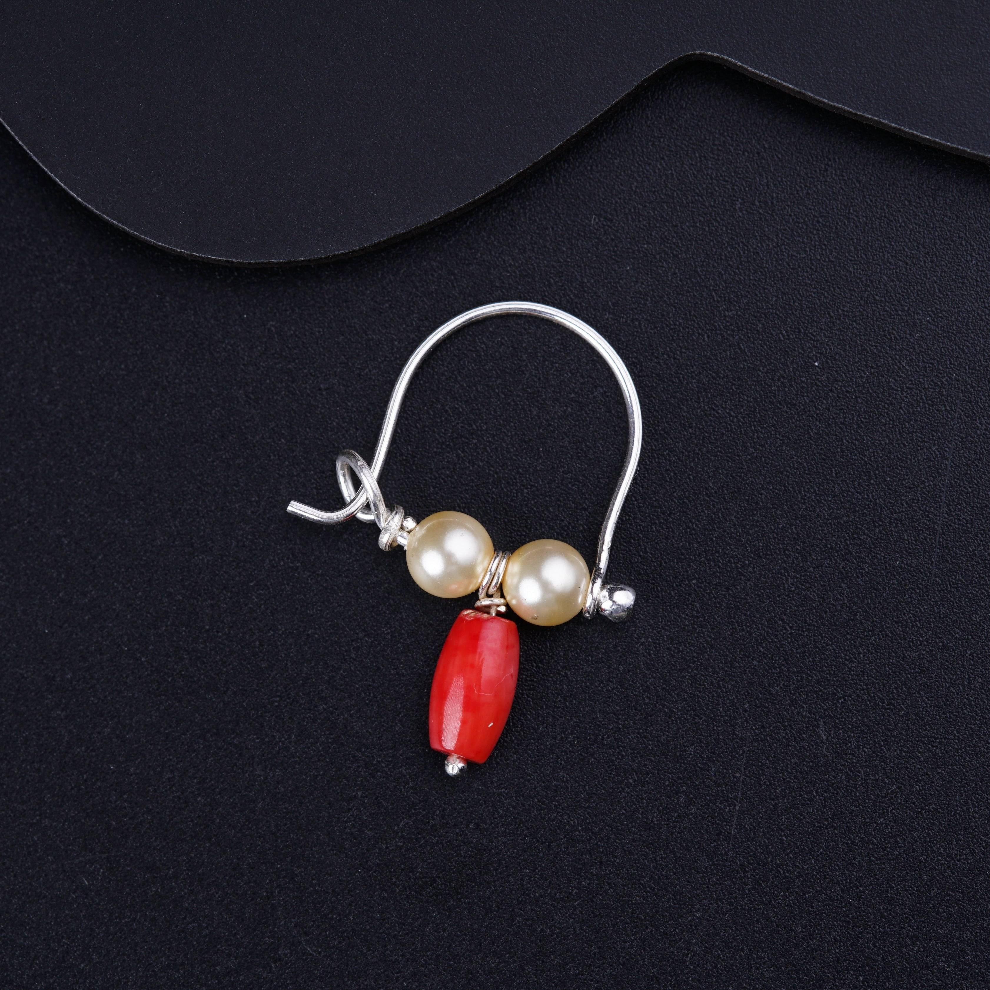 a pair of earrings with a red and white bead