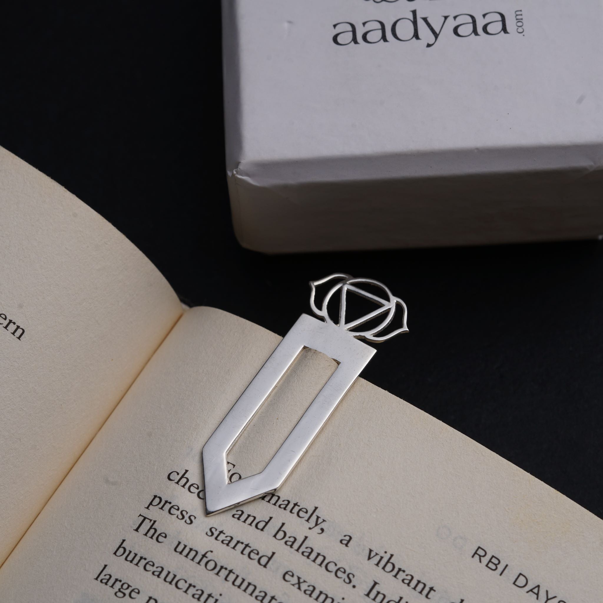 an open book with a metal object on top of it