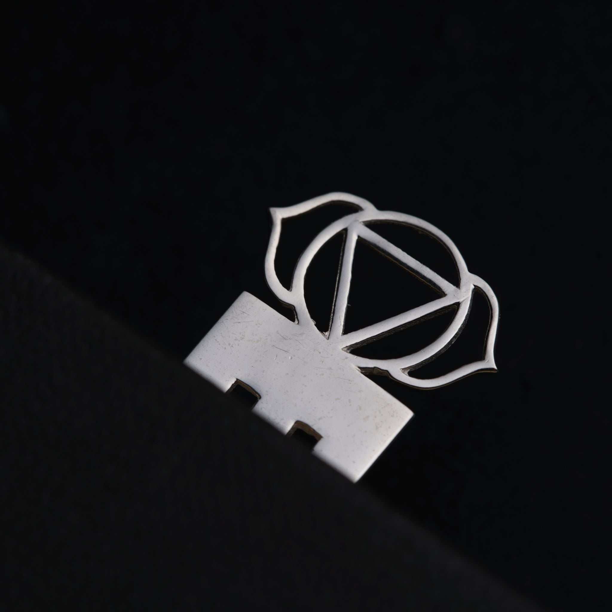 a close up of a metal object on a black surface