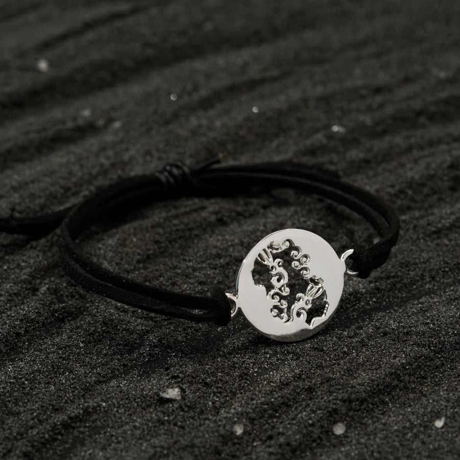 a black and white photo of a bracelet
