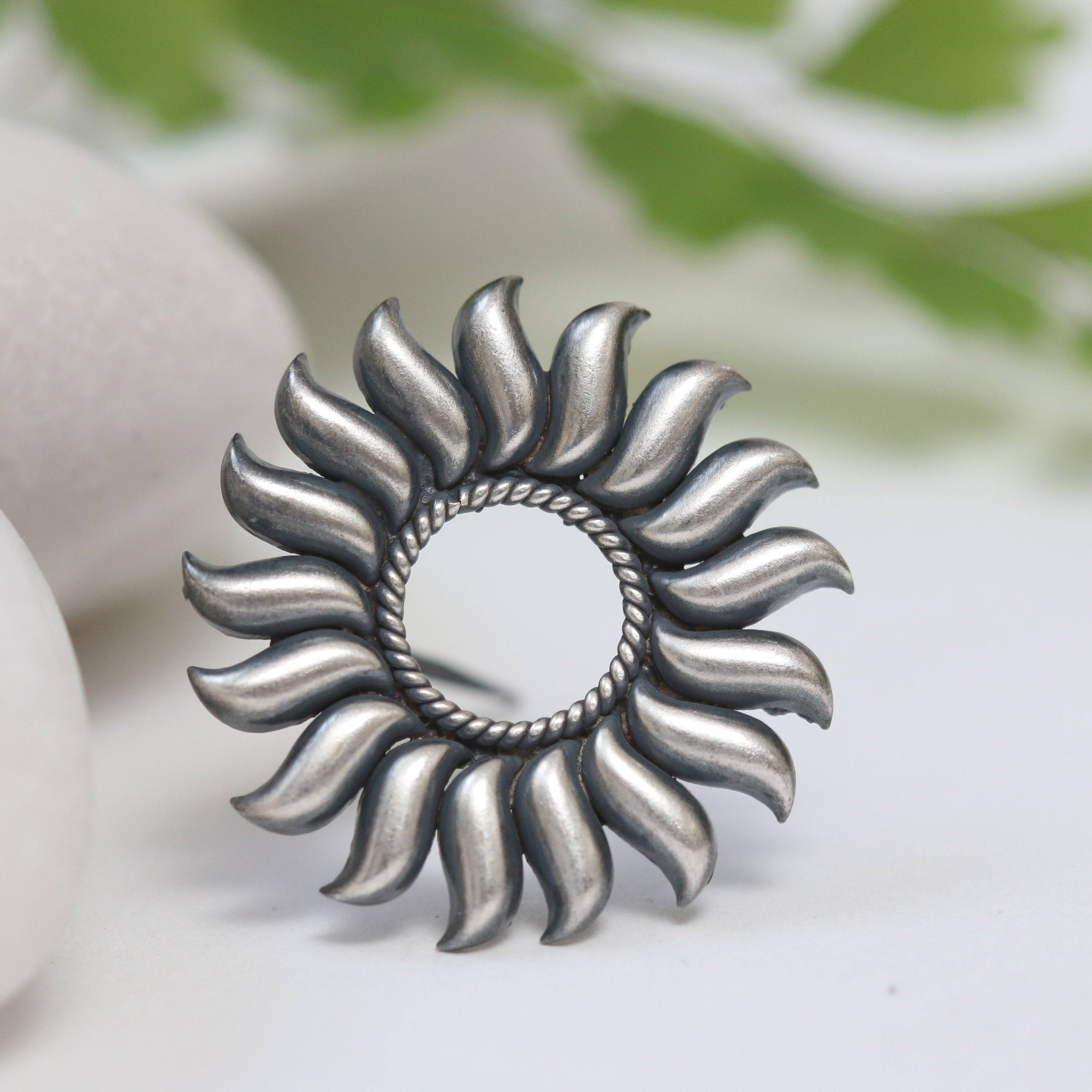 a silver ring sitting on top of a white table