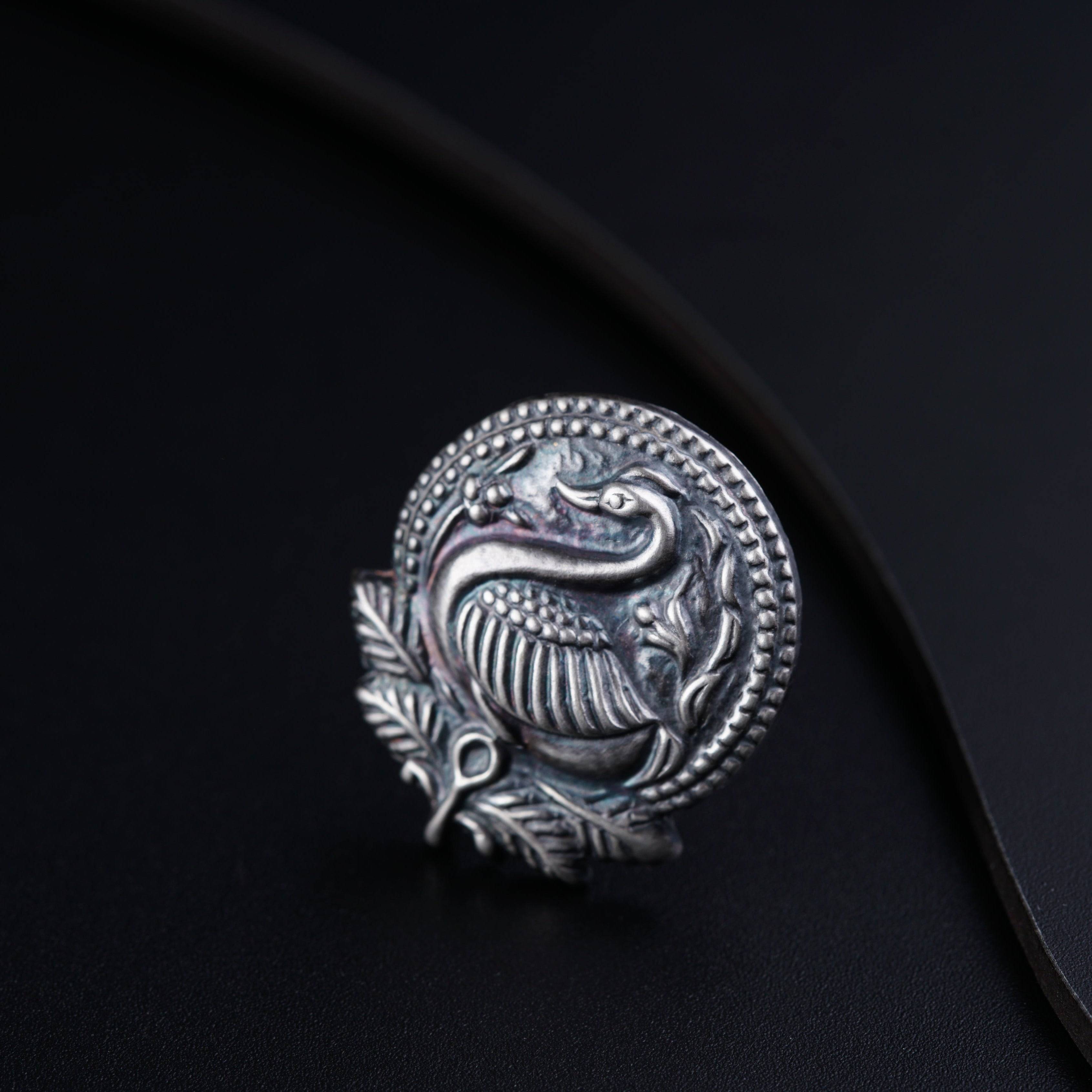 a silver ring with a dragon on it