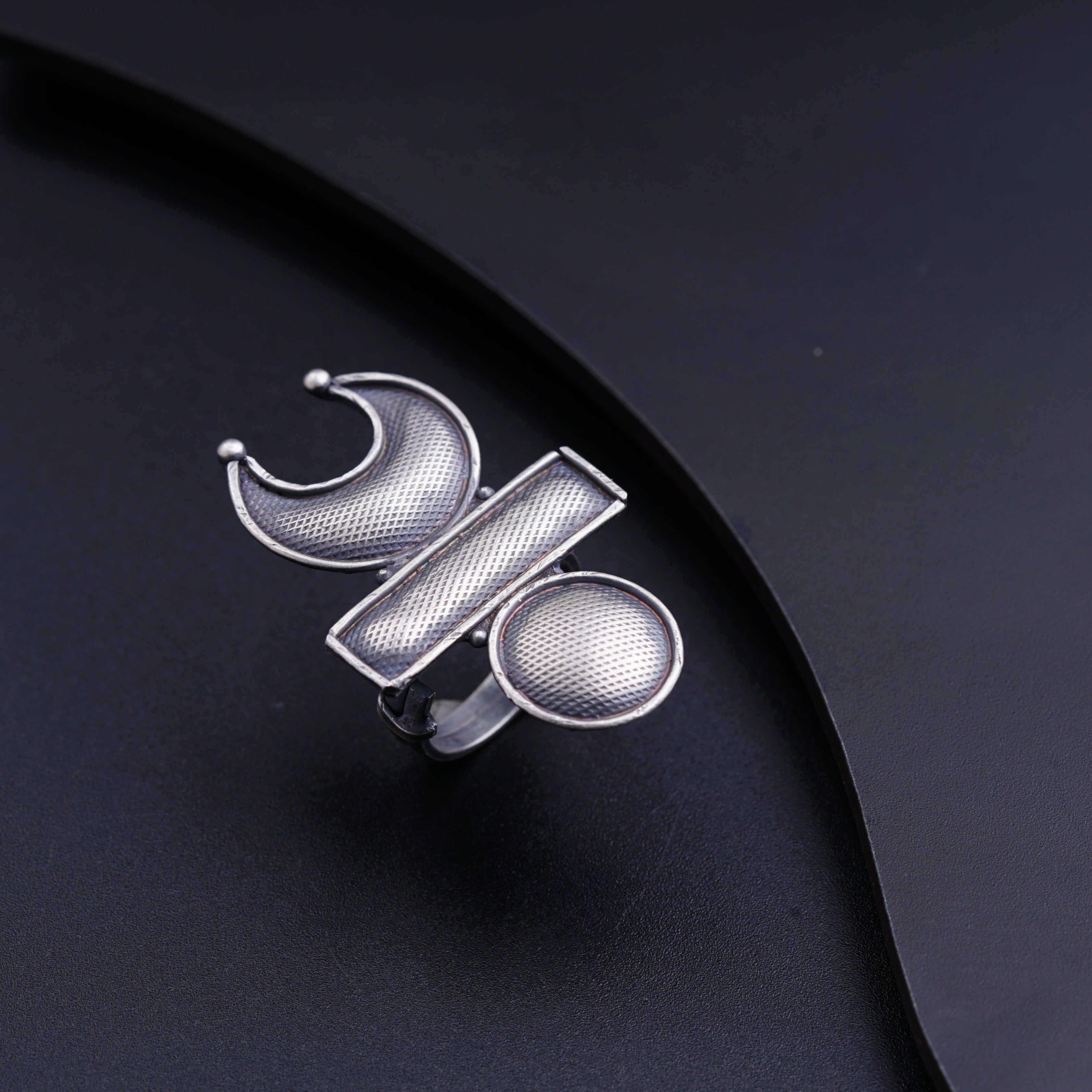 a close up of a metal object on a black surface