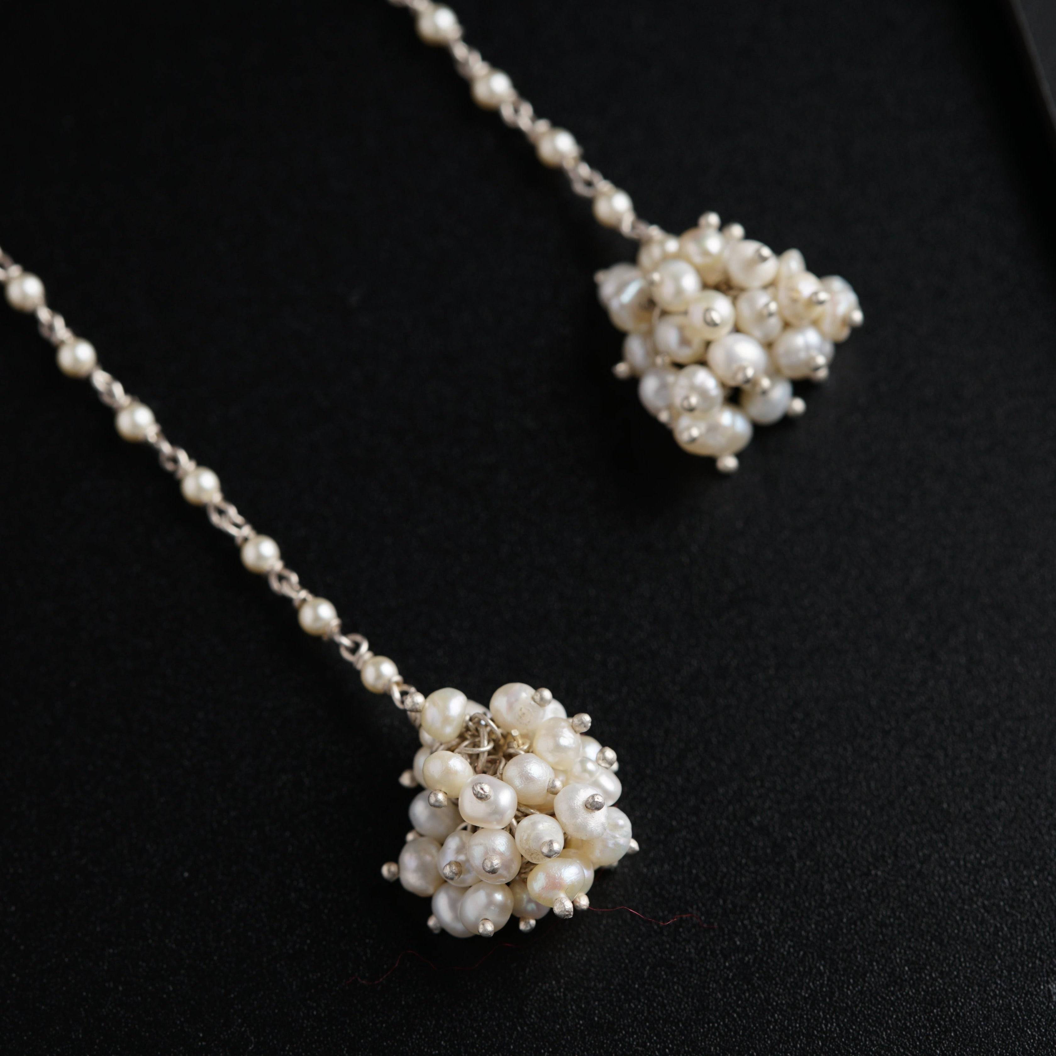 a close up of a necklace on a black surface