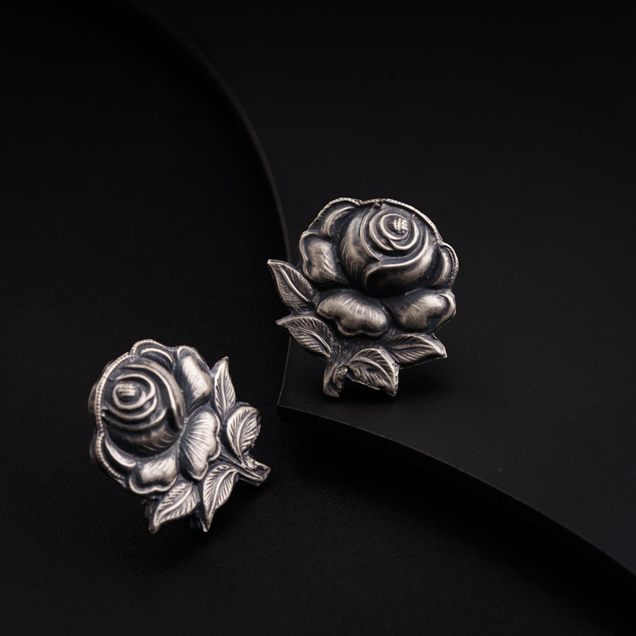 a pair of silver roses on a black background