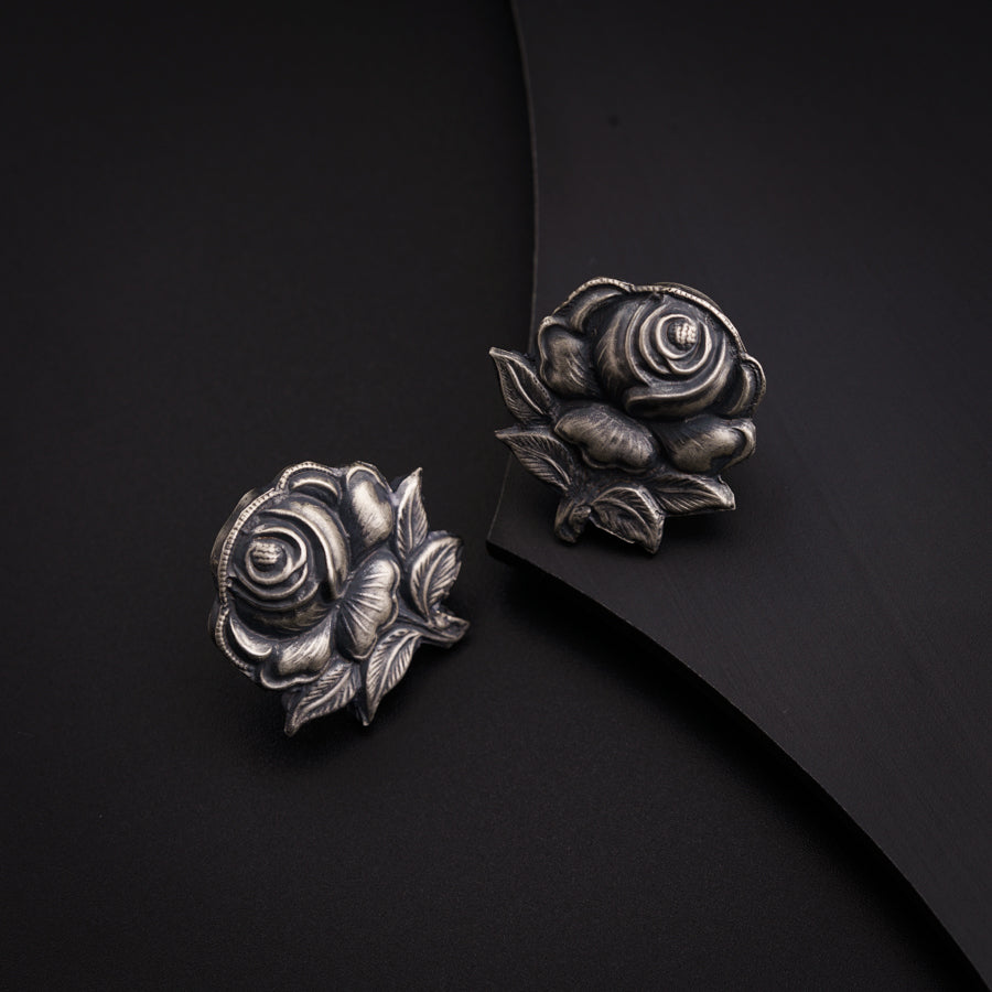 a pair of silver roses on a black background