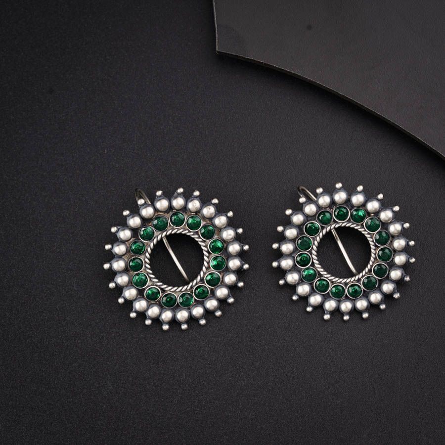 a pair of green and white beaded earrings