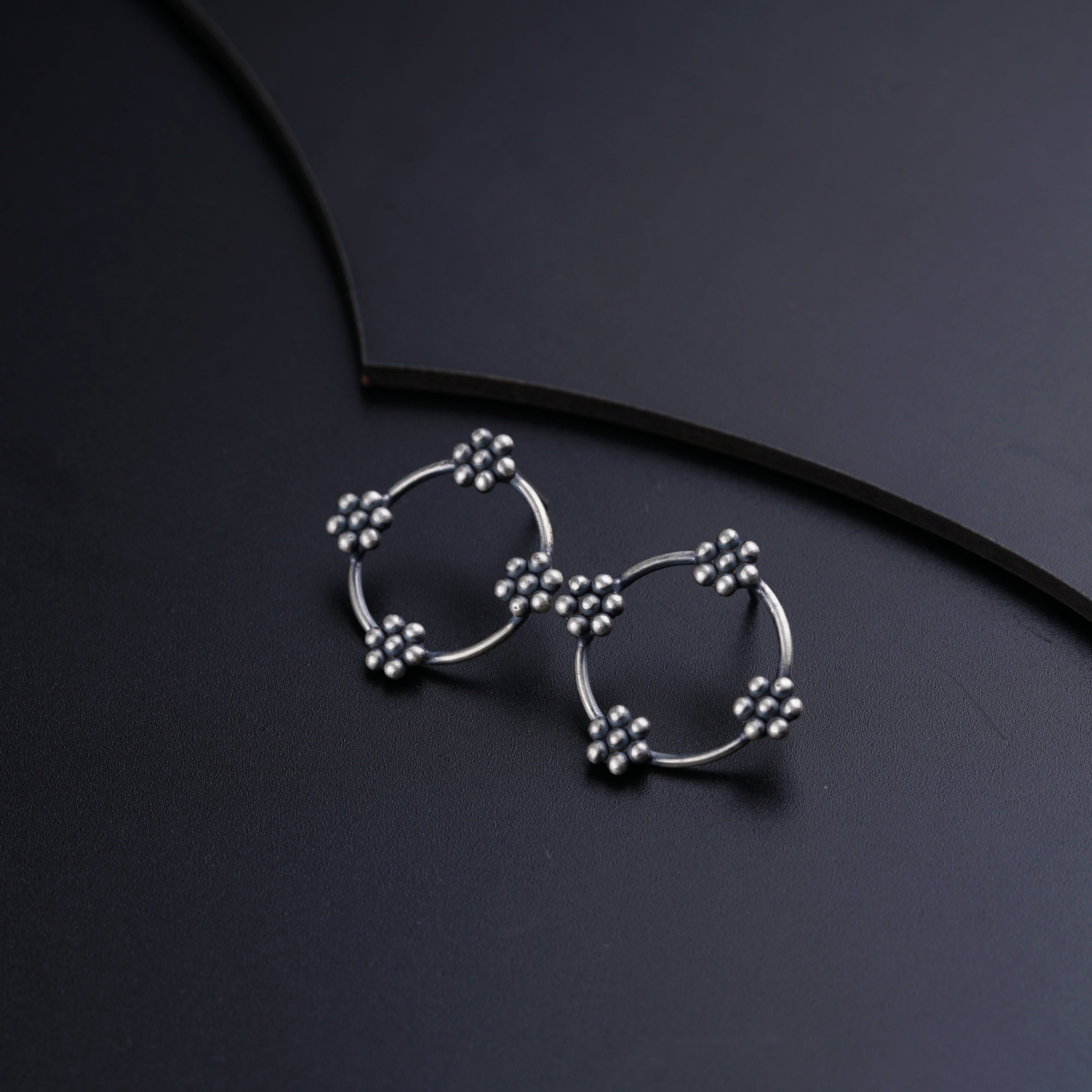 a pair of earrings sitting on top of a table