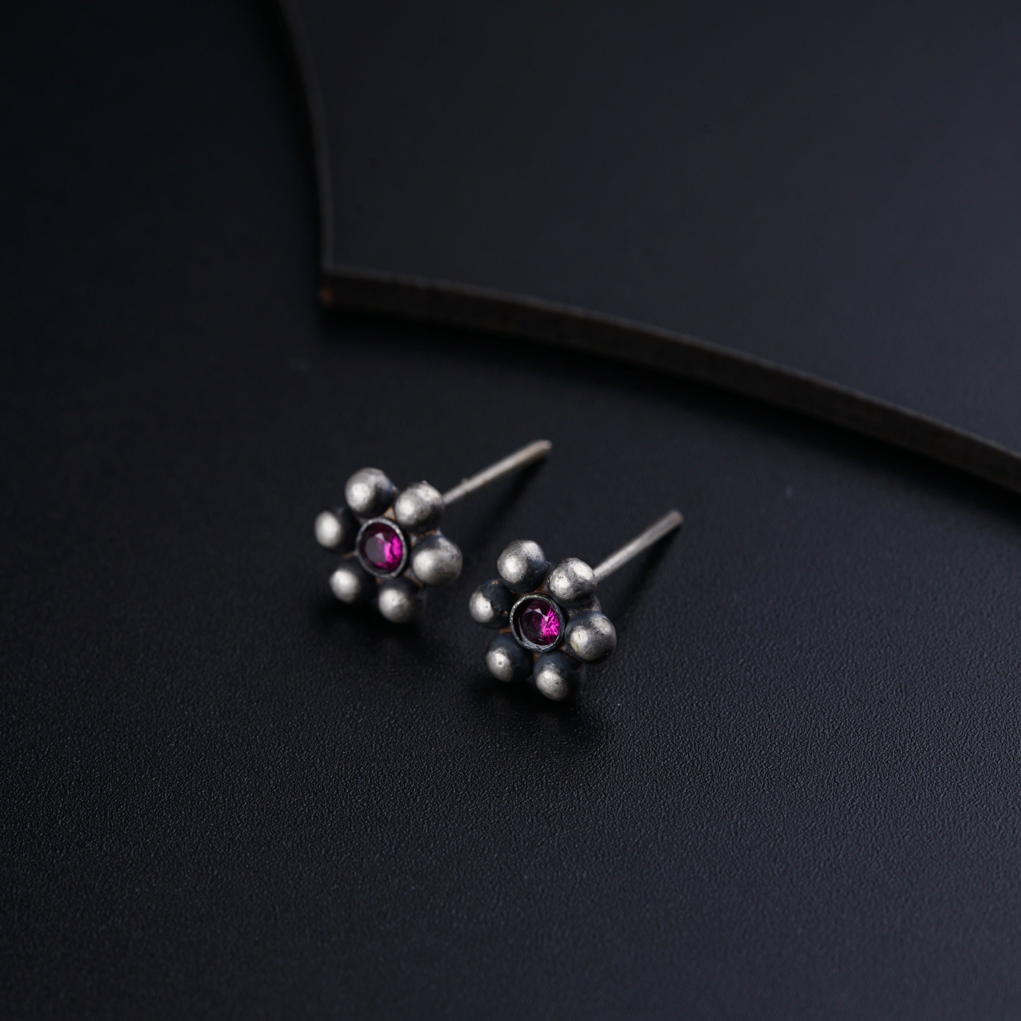 a pair of silver and pink stone earrings