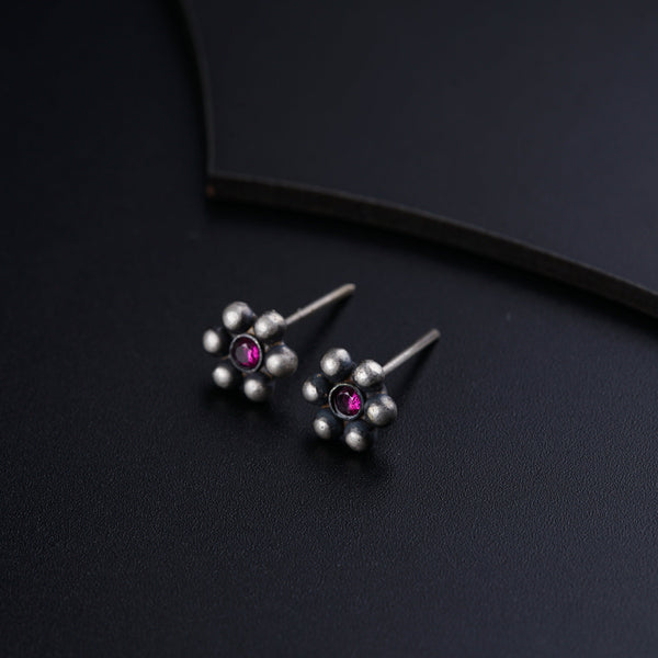 a pair of silver and pink stone earrings