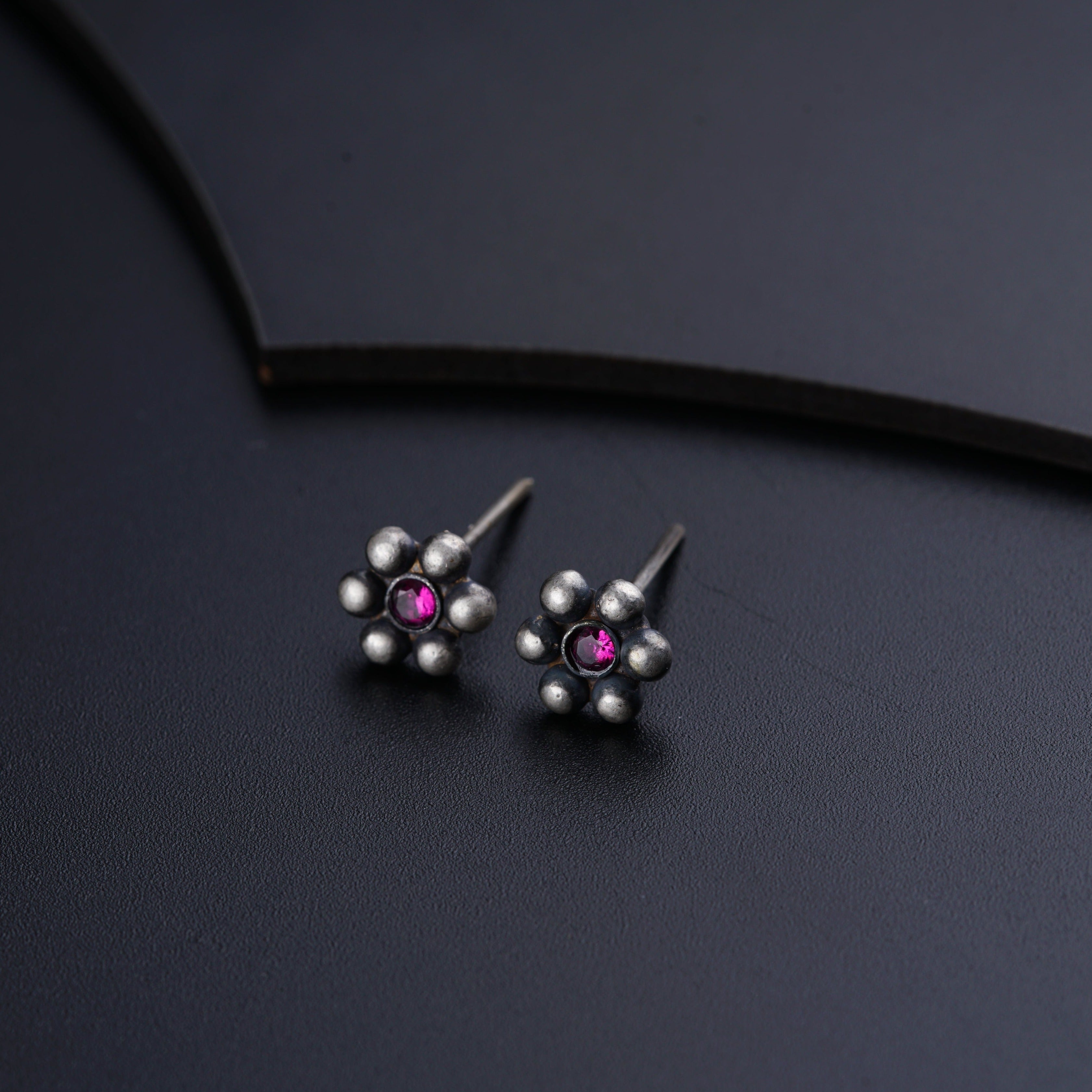 a pair of silver and pink stone earrings