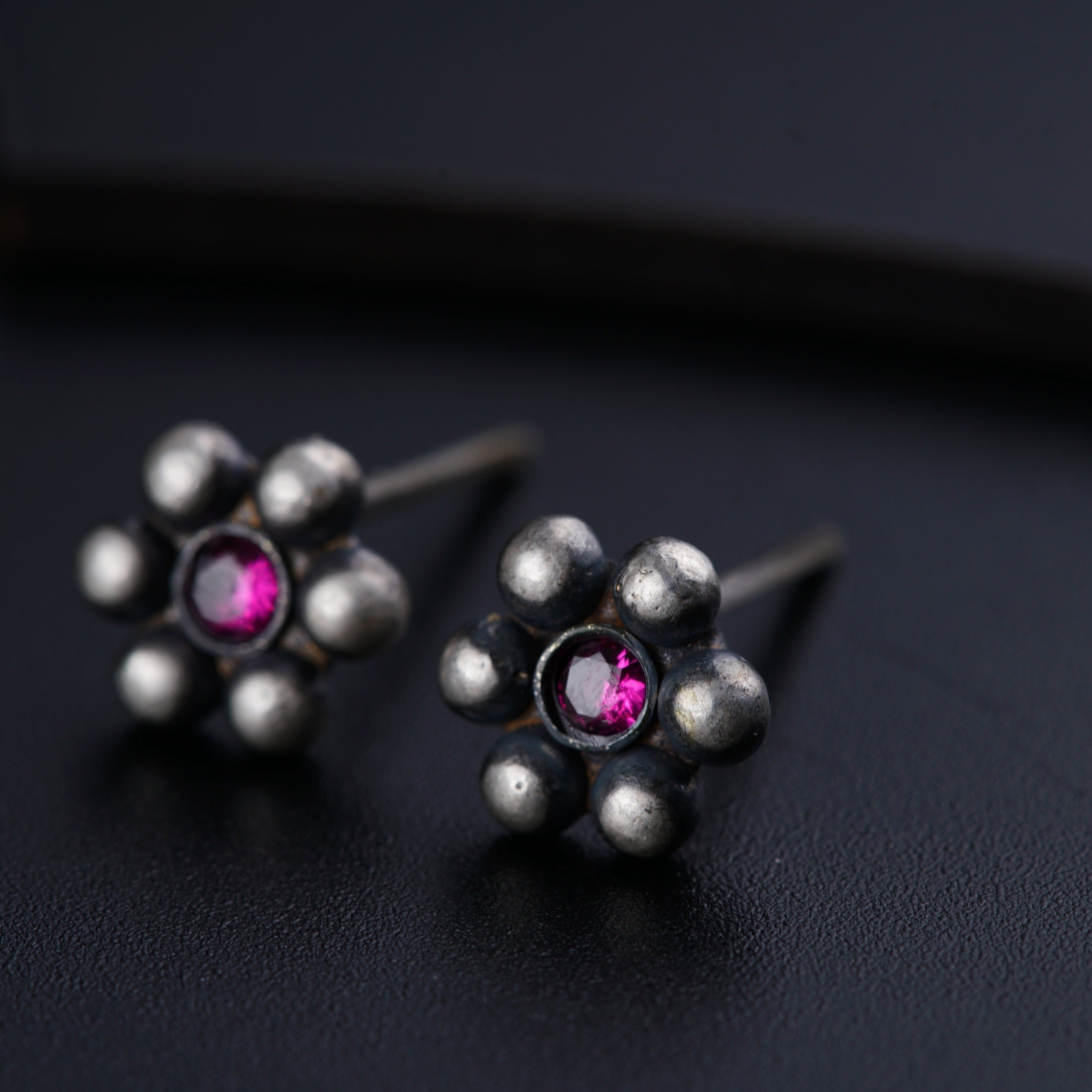 a pair of silver and pink stone earrings