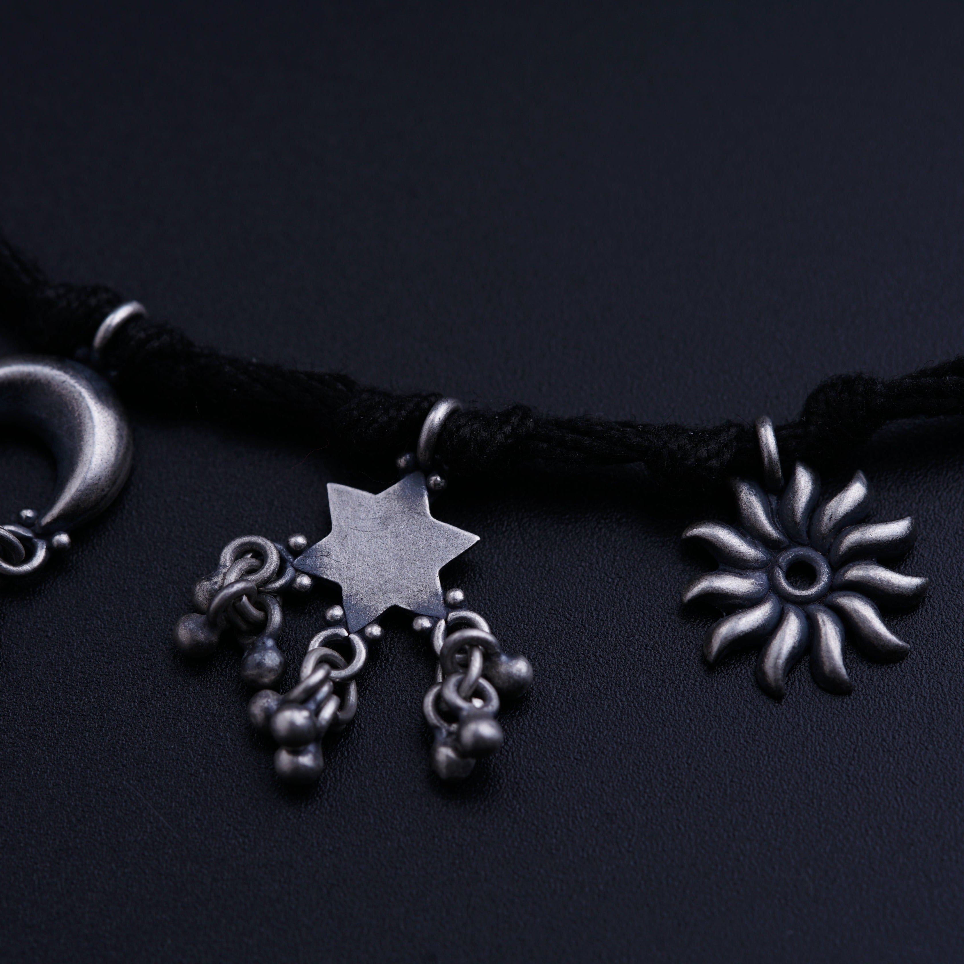 a necklace with a star and a moon on it