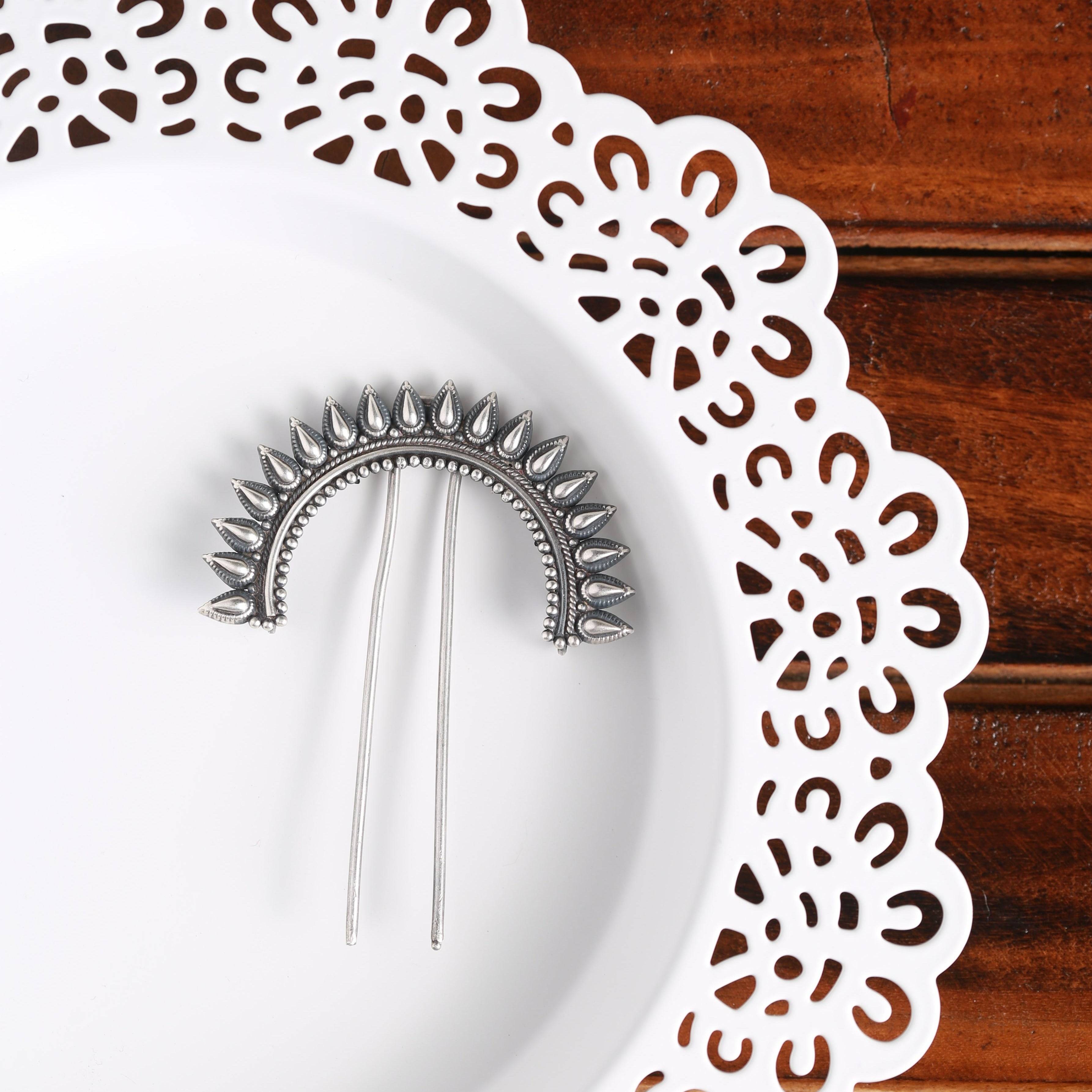 a pair of needles sitting on top of a white plate