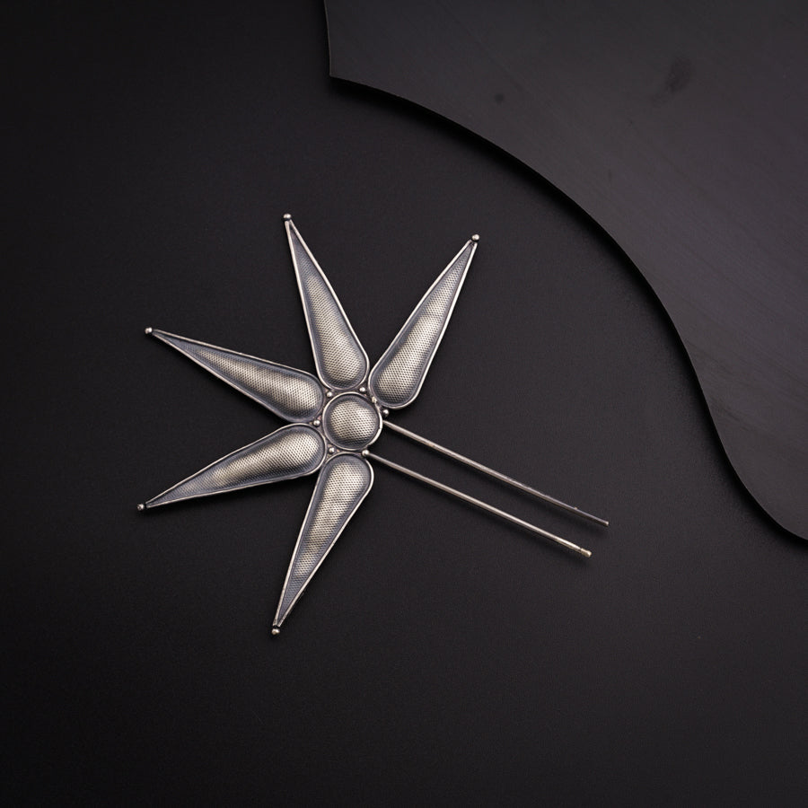 a knife and a star shaped object on a black surface