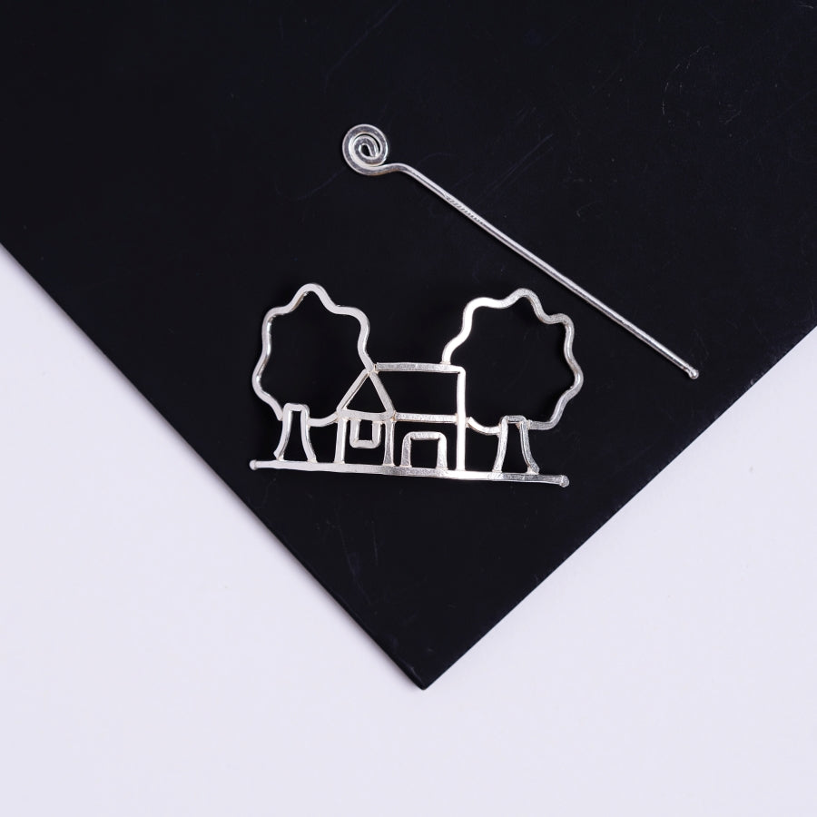 a pair of earrings is shown on a black surface