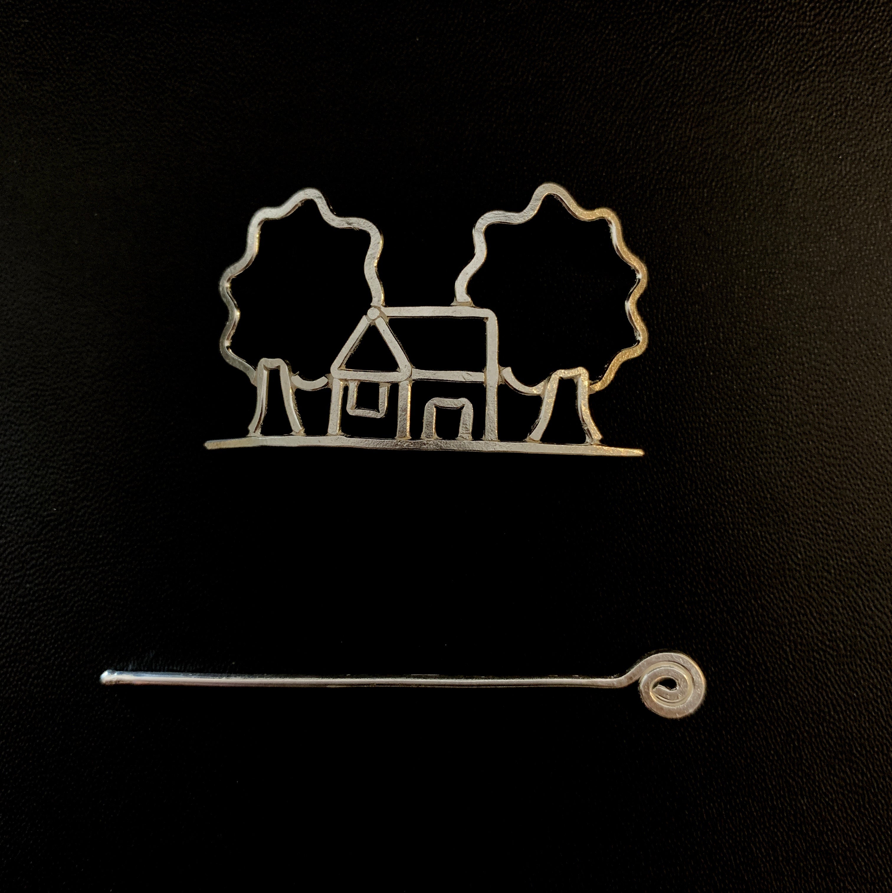 a cookie cutter with a house and trees on it