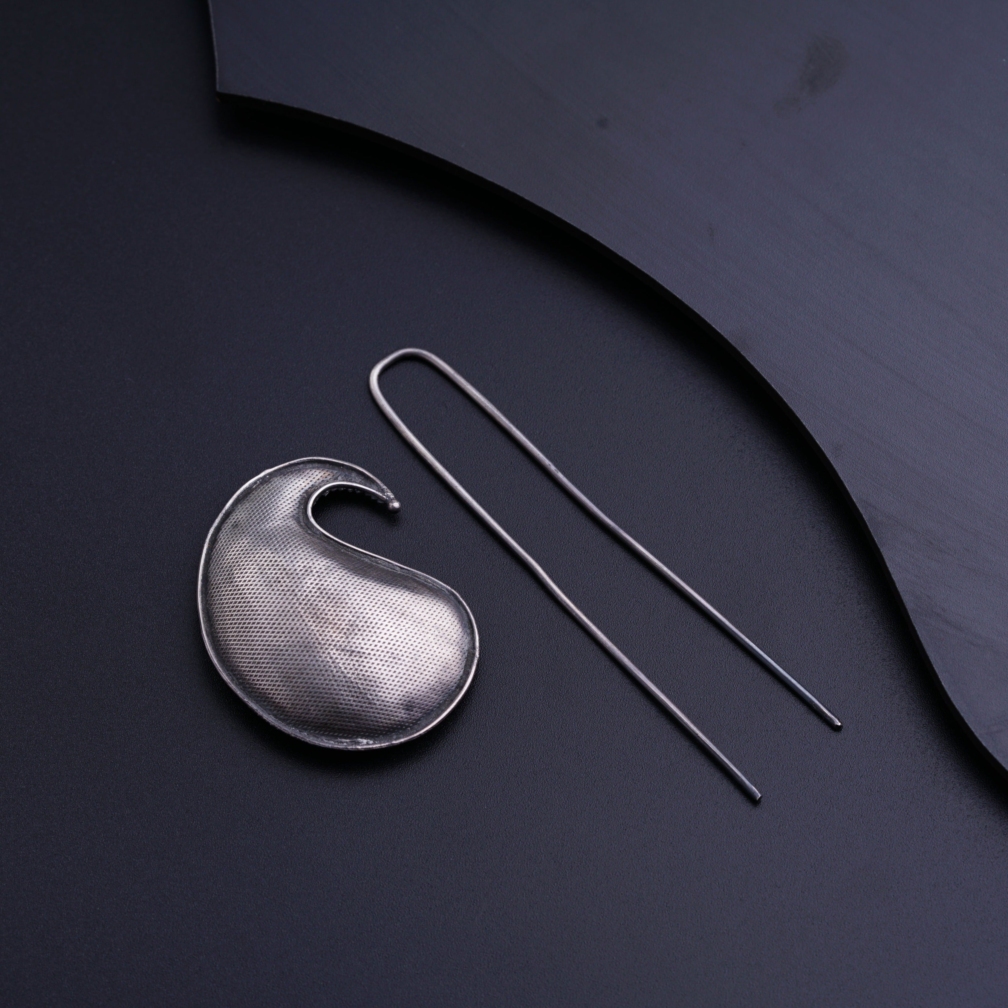 a pair of scissors next to a metal object