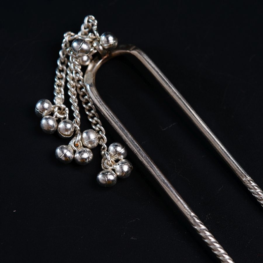 a close up of a metal object on a black surface