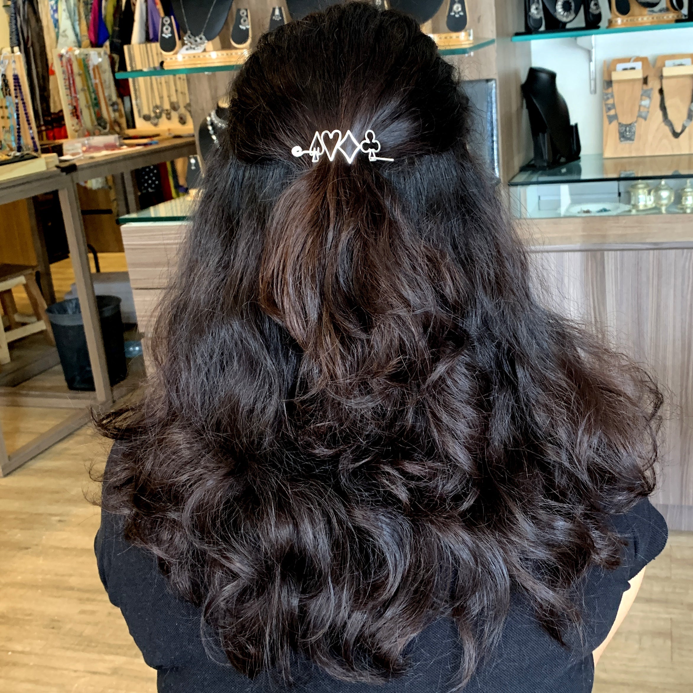 the back of a woman's head with a hair clip in her hair