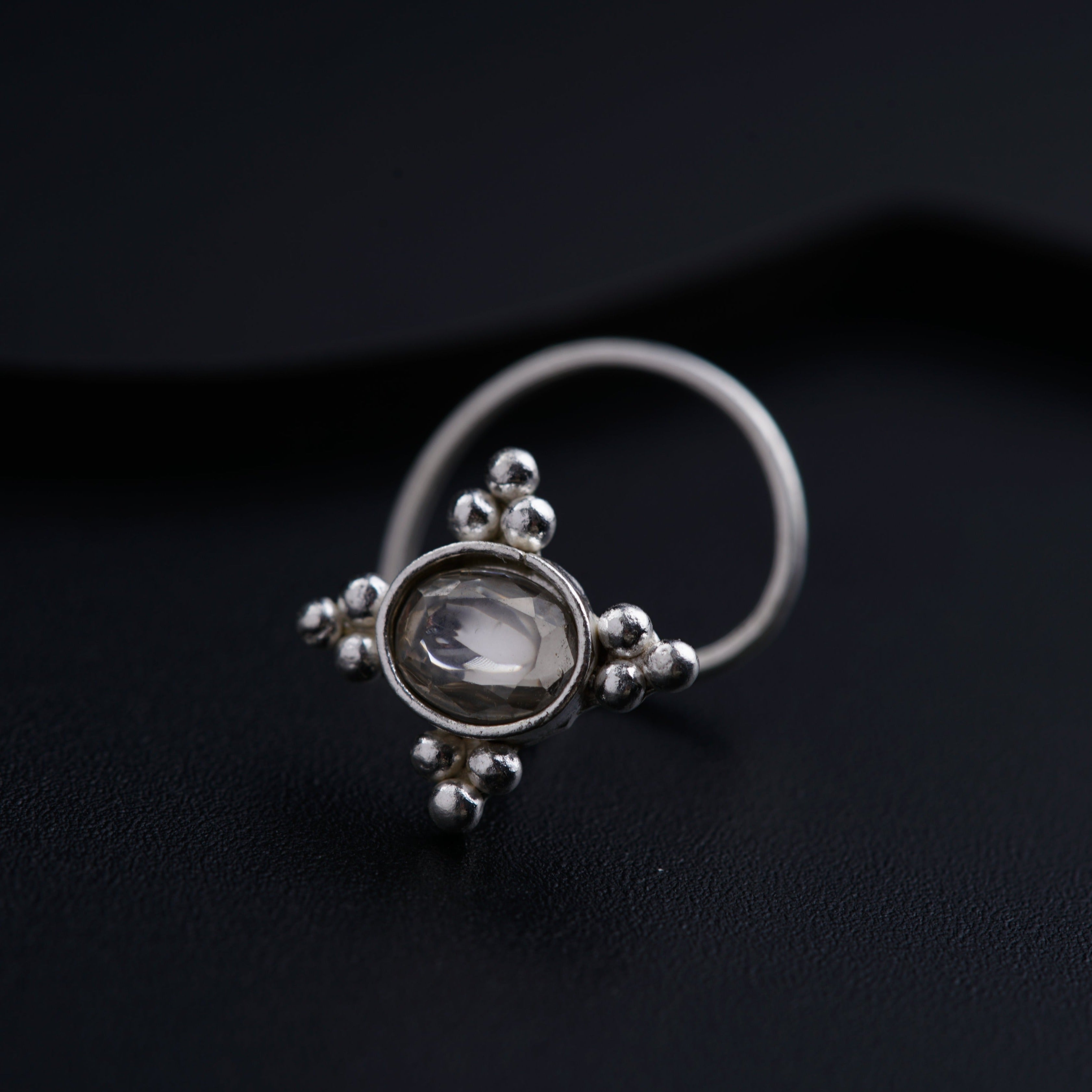 a close up of a ring on a black surface