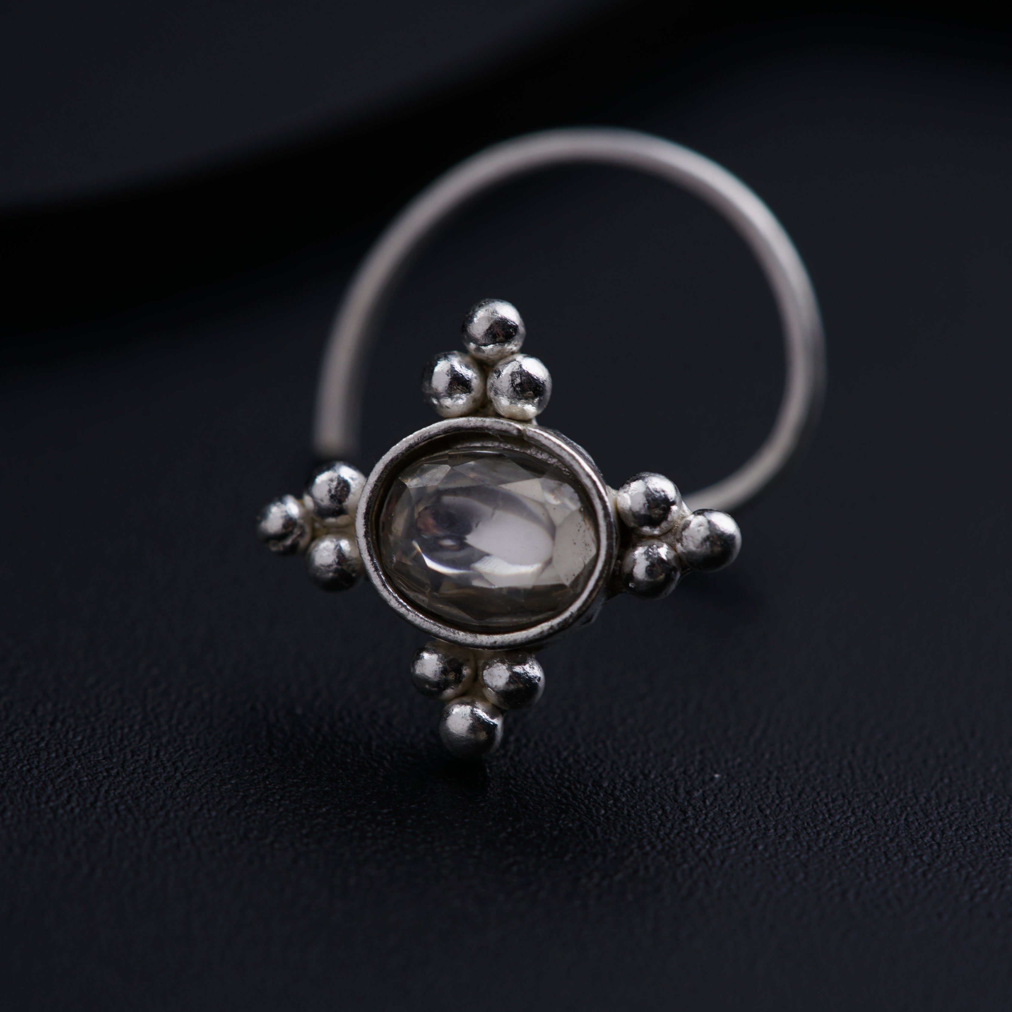 a close up of a ring on a black surface