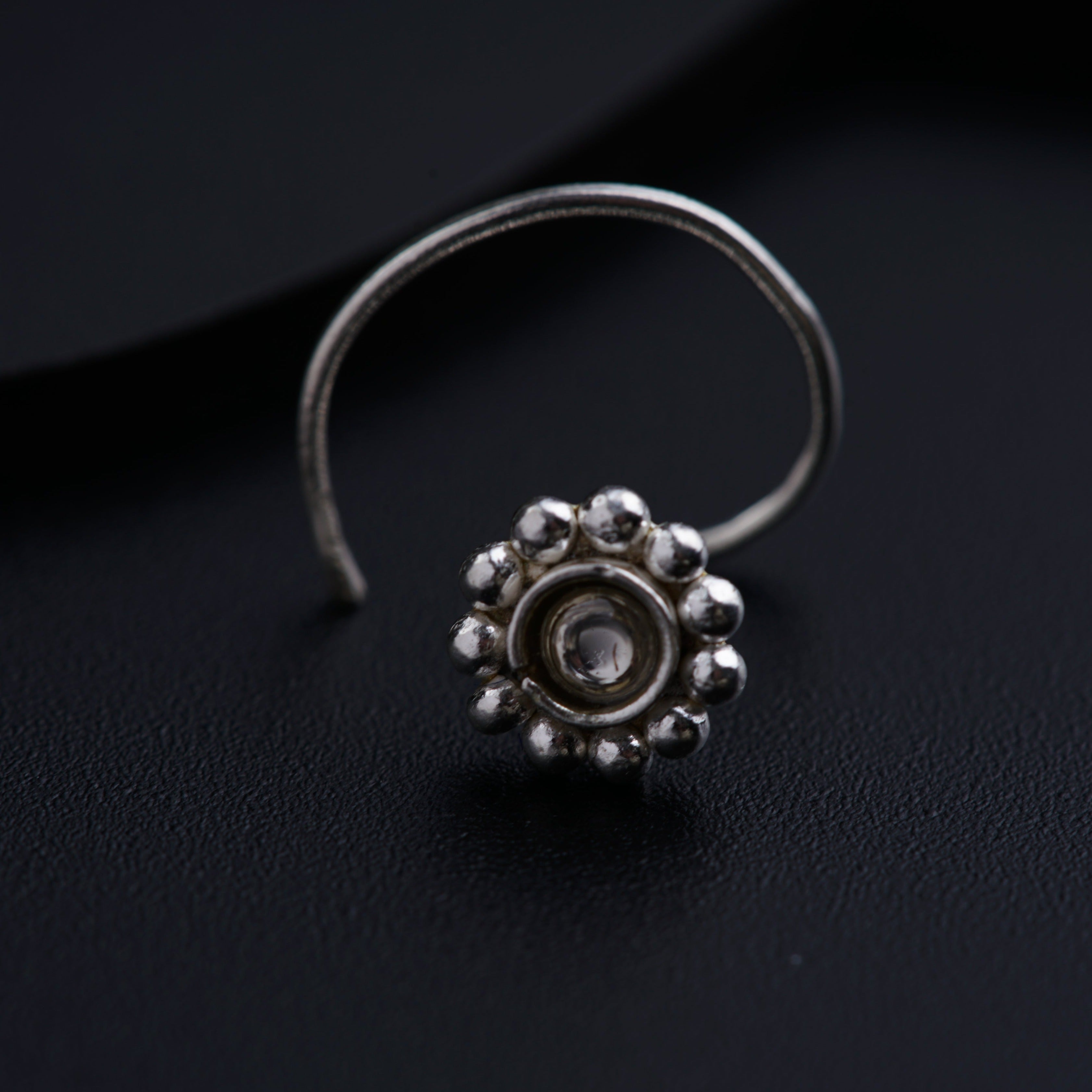 a close up of a ring on a black surface