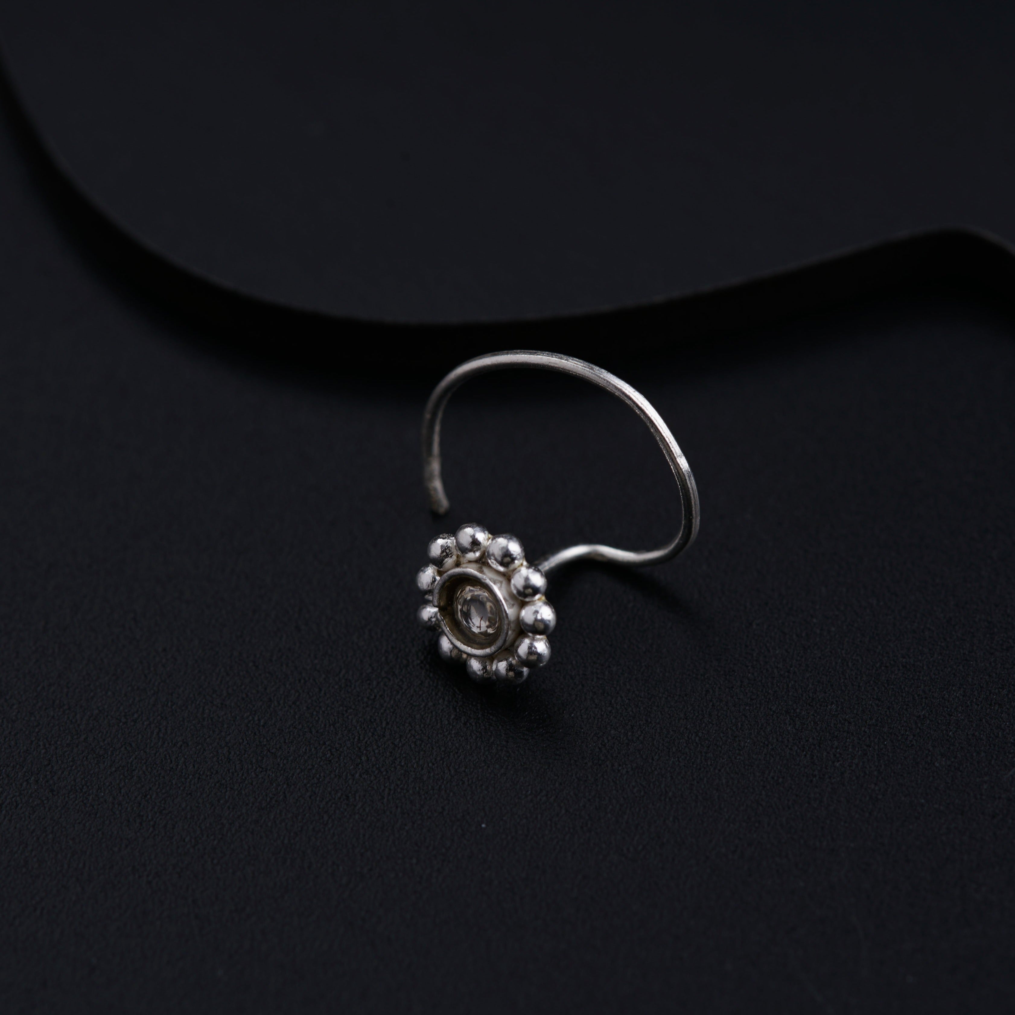 a close up of a ring on a black surface
