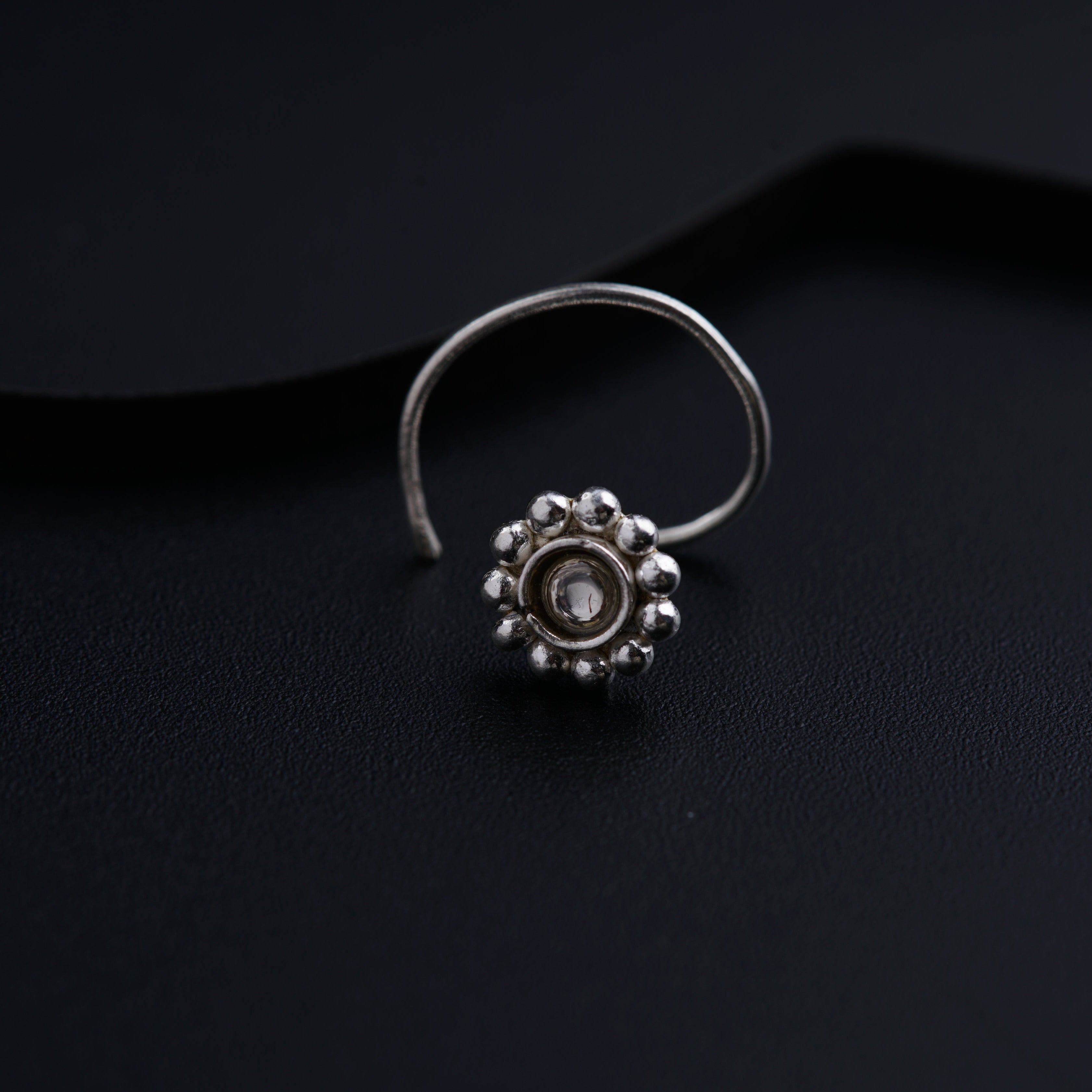 a close up of a ring on a black surface