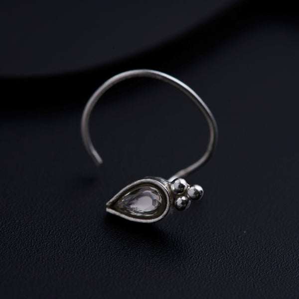 a close up of a pair of earrings on a black surface