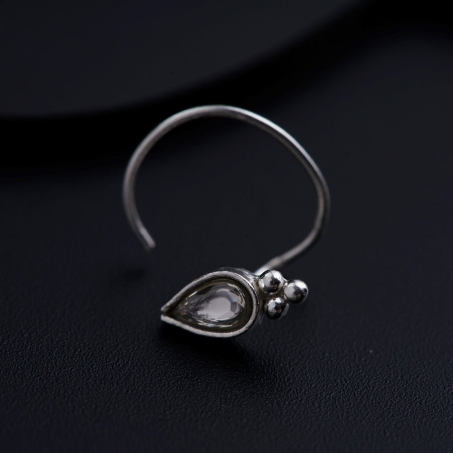 a close up of a pair of earrings on a black surface