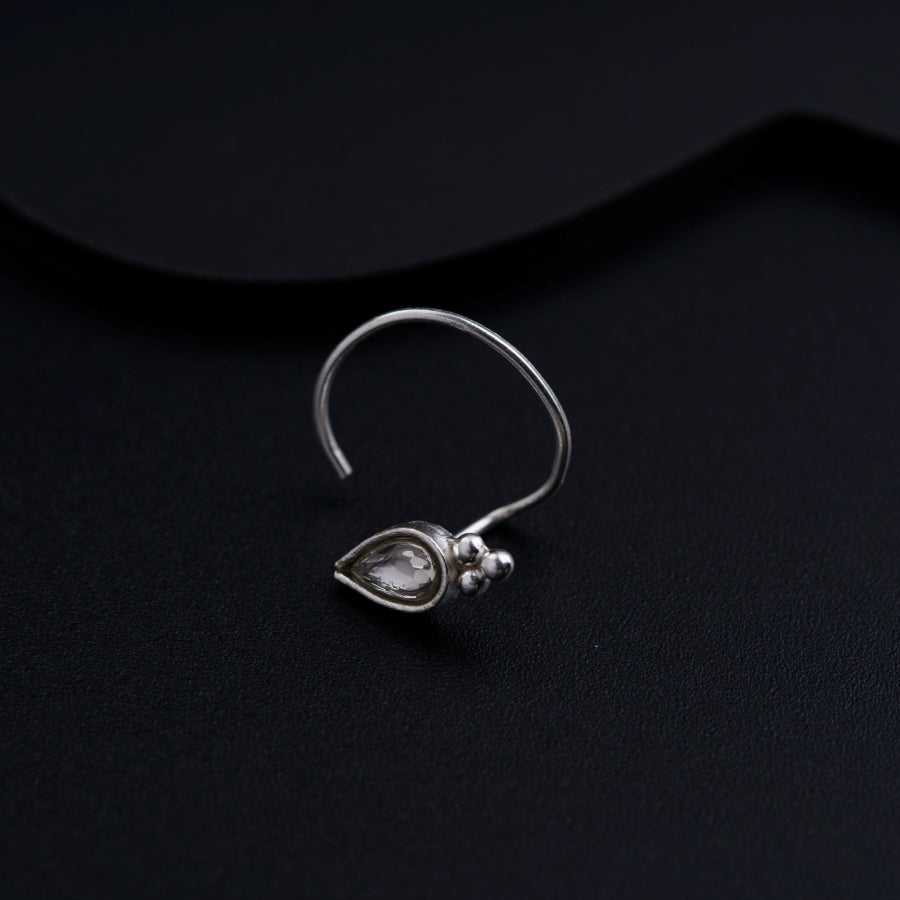 a close up of a pair of earrings on a black surface