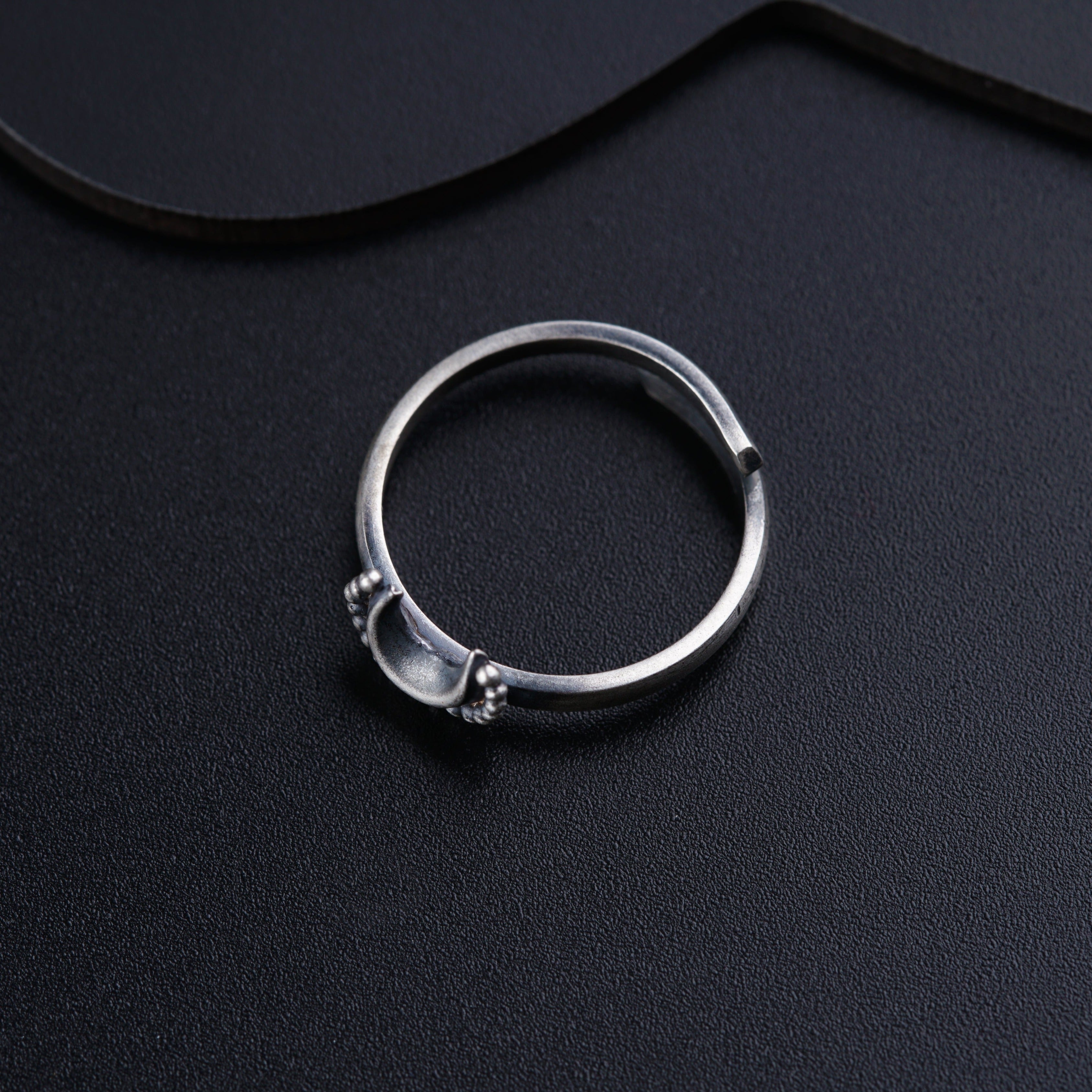 a close up of a ring on a black surface