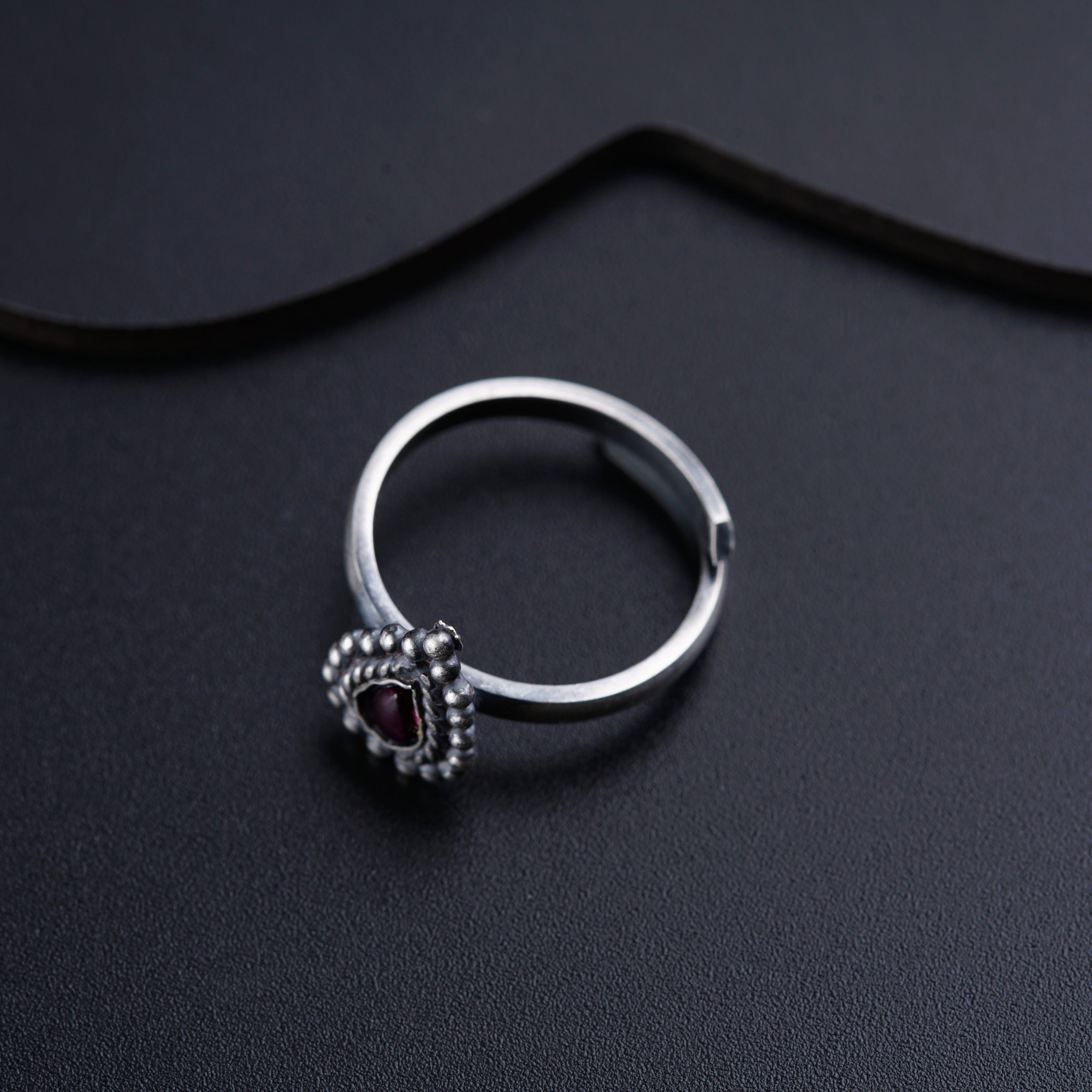 a close up of a ring on a black surface