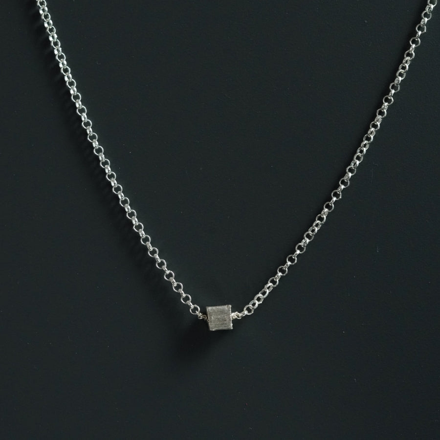 a silver chain with a square pendant on it