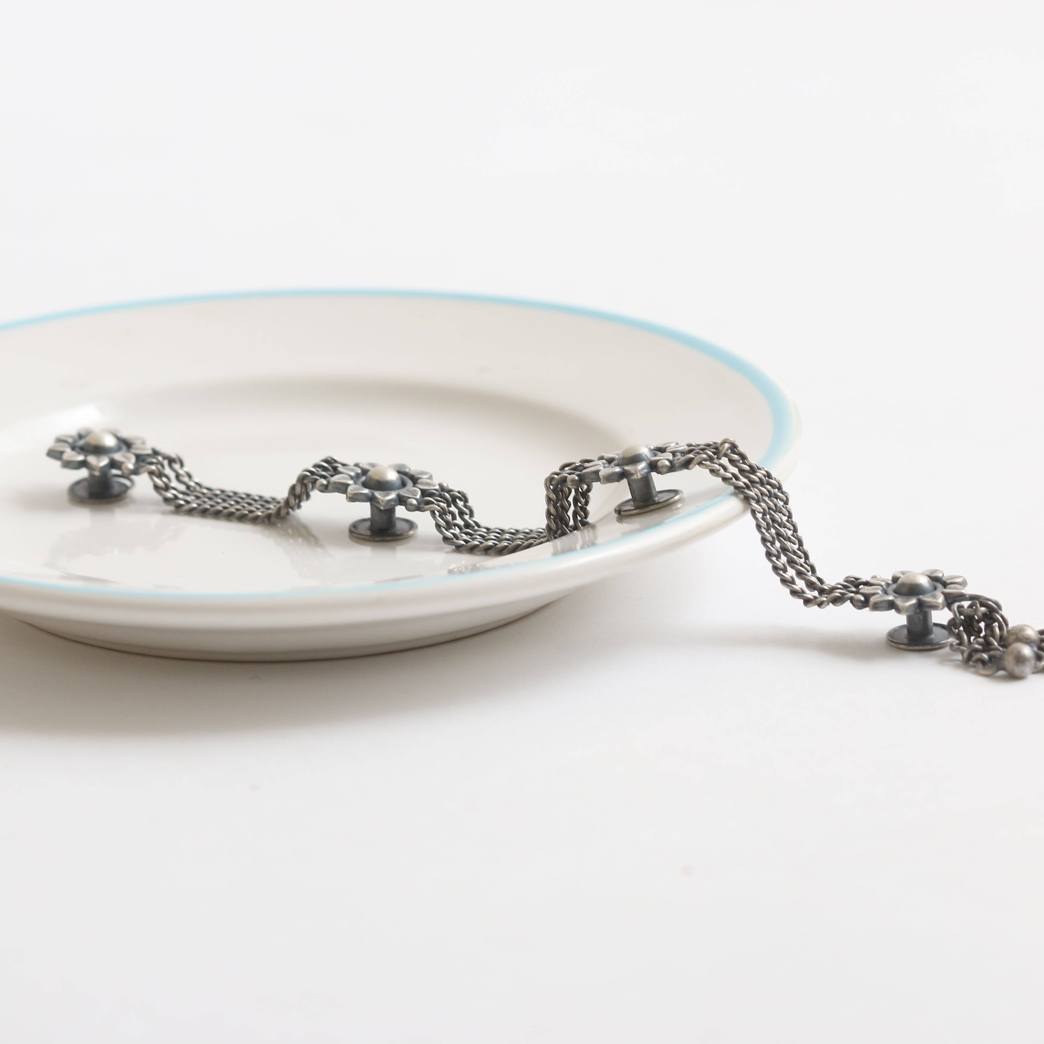 a white plate with a chain on it