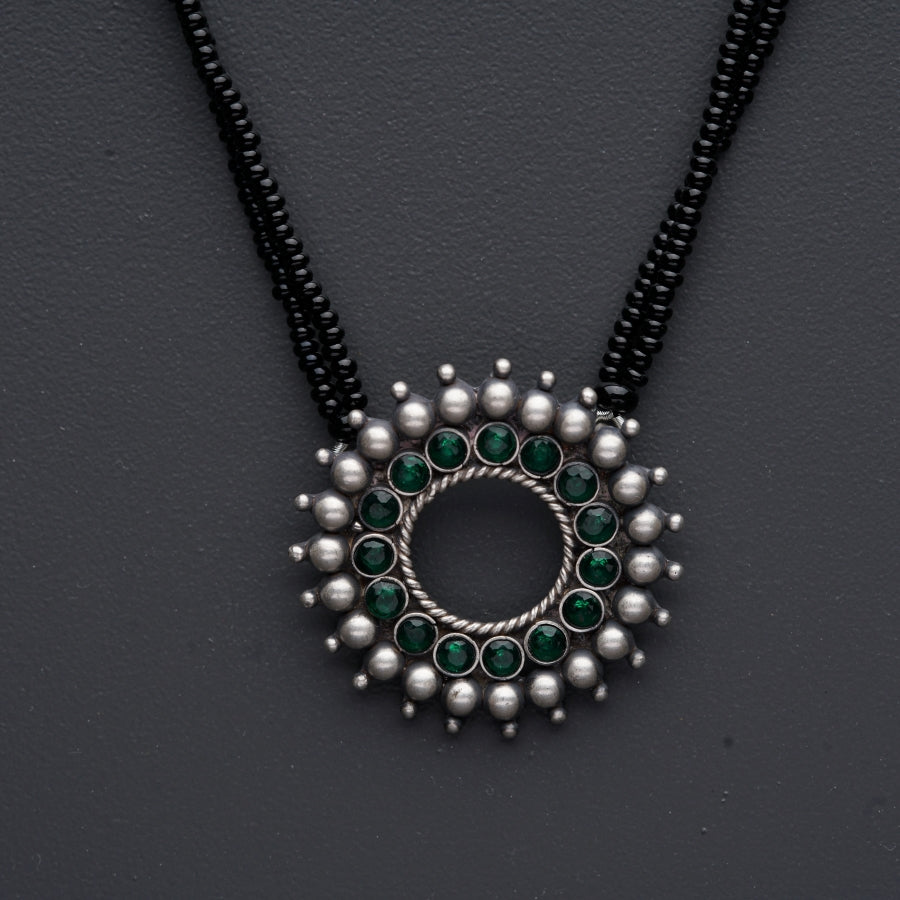 a black beaded necklace with a circular design