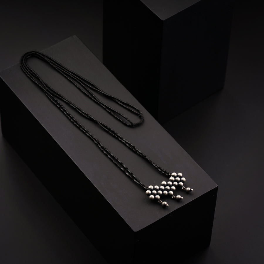 a black box with three necklaces on it