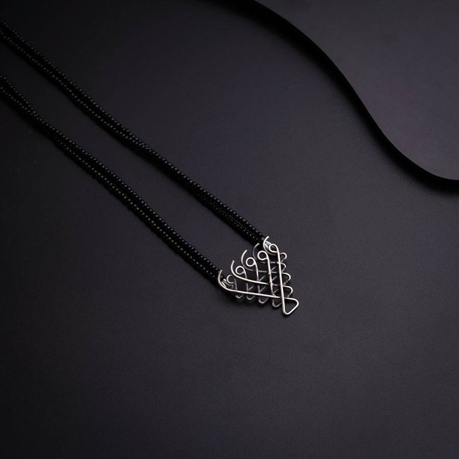 a black necklace with a heart shaped pendant