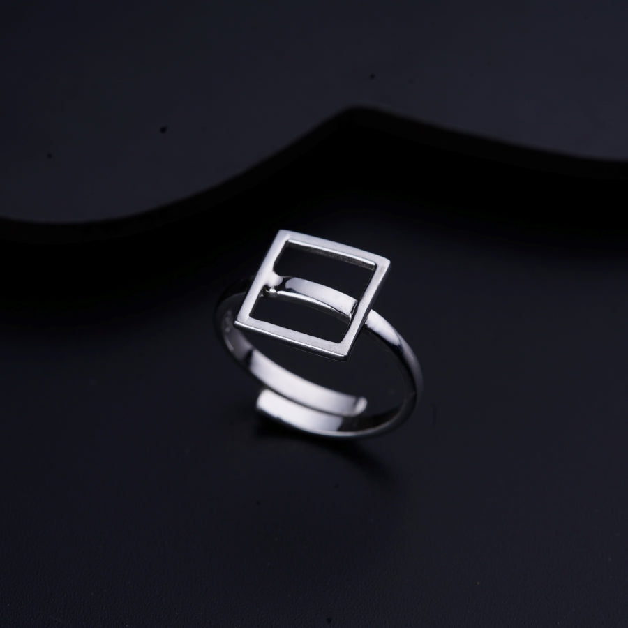 a silver ring on a black surface