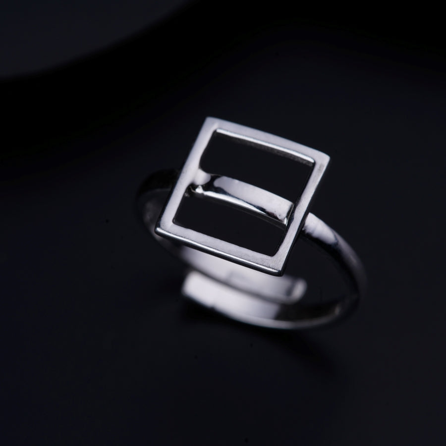 a silver ring with a square design on it