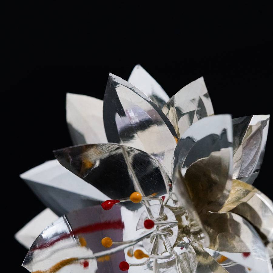 a close up of a flower made out of mirrors