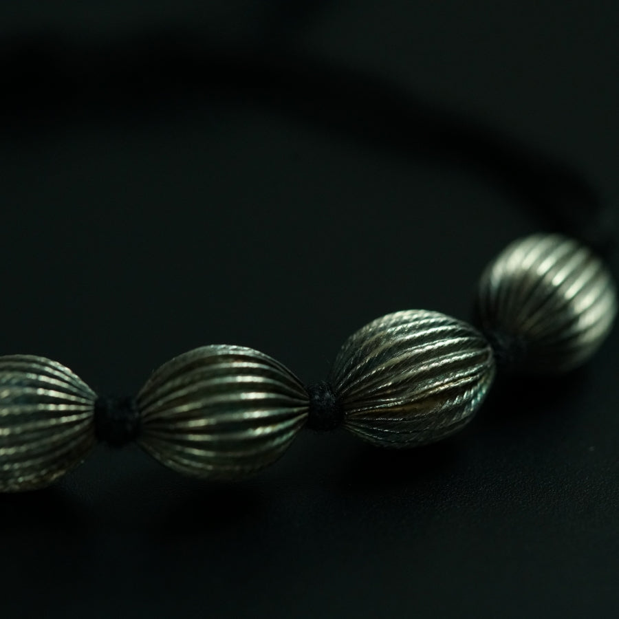 a close up of a bracelet on a black surface