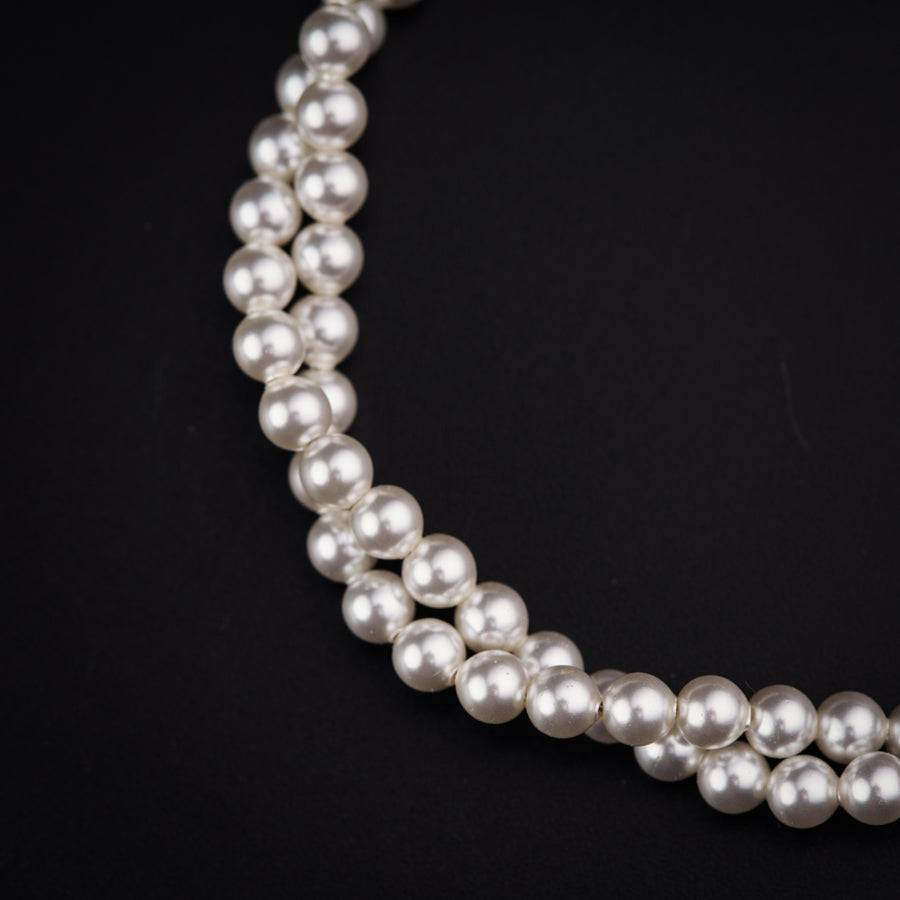 a close up of a necklace on a black background