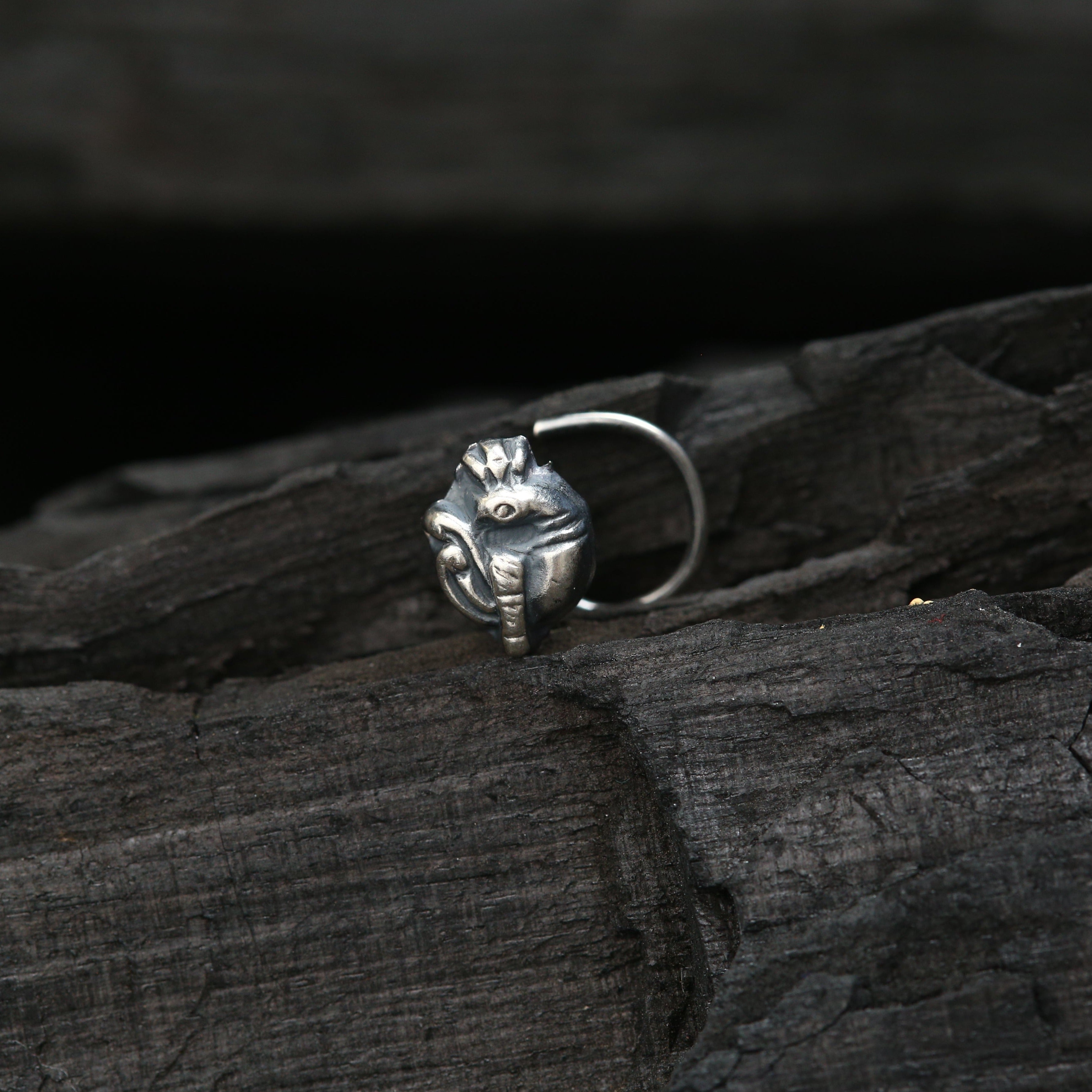 a close up of a ring on a piece of wood
