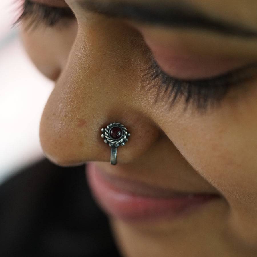 a close up of a person with a nose piercing