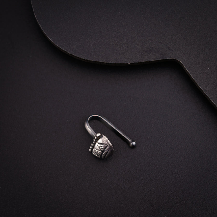 a pair of earring sitting on top of a black surface