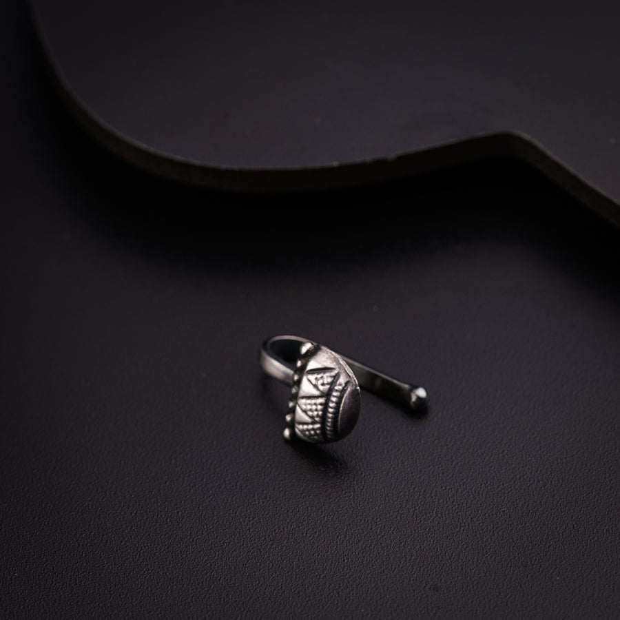 a silver ring sitting on top of a black table