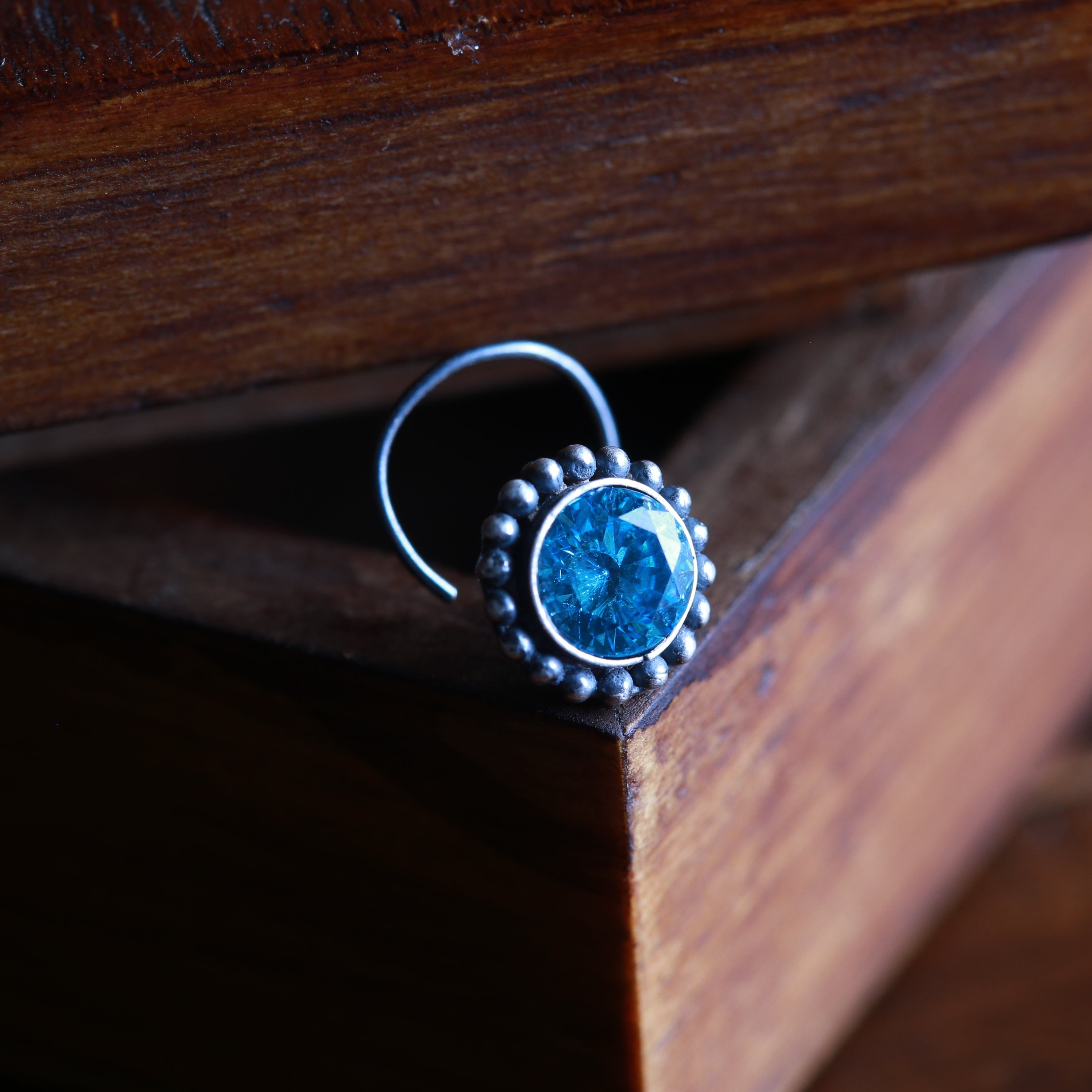 a close up of a ring with a blue stone