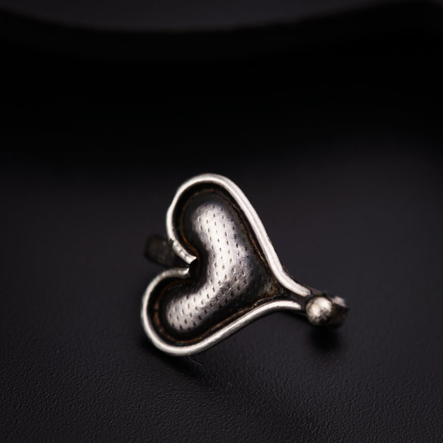 a silver ring with a heart on it